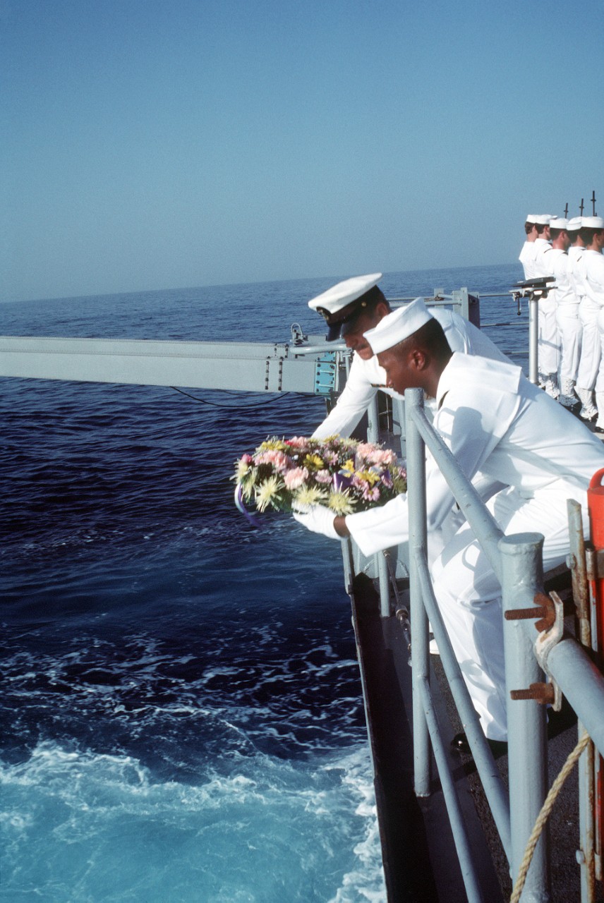 330-CFD-DN-ST-88-07618:  Wreath-Laying Memorial, 1989.    Members of the color guard stand at attention during a wreath laying memorial service aboard the destroyer USS Stump (DD-978).  The ceremony is being held to honor the 37 sailors who lost their lives when the guided missile frigate USS Stark (FFG-31) was hit by an Iraqi-launched Exocet missile exactly one year ago.   U.S. Navy Photograph, now in the collections of the U.S. National Archives.
