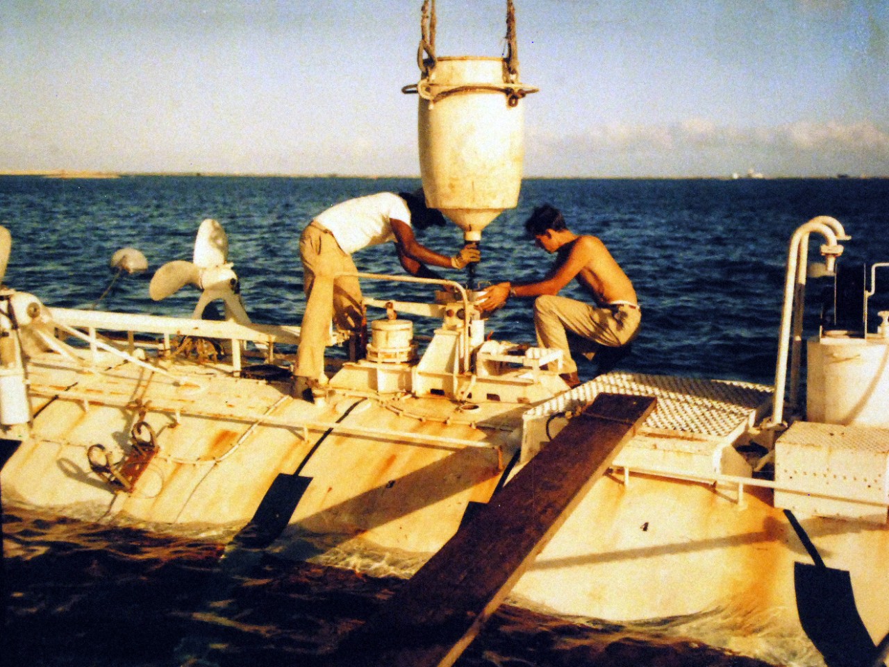 428-GX-KN-690:  U.S. Navy Bathyscaph Trieste, 1959.       Ship Repair Facility, Guam.  Jacques Piccard and Earnest Vigil load iron shot, which is used for ballast of the vessel, onboard the bathyscaph Trieste.  Photographed November 12, 1959.  (U.S. Navy Photograph now in the collections of the National Archives.  Note, photographed from reference card only.  (2016/02/17).  