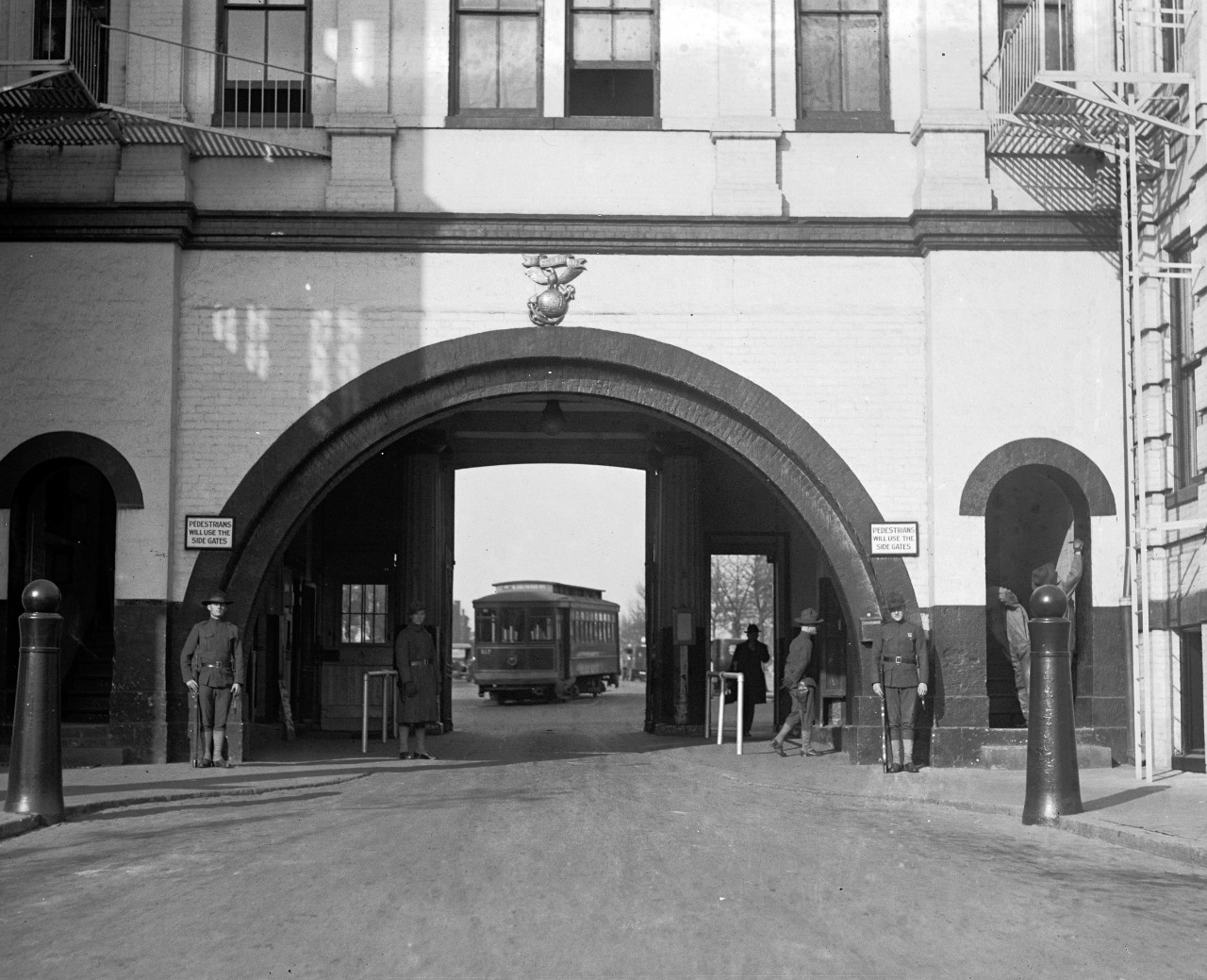 LC-DIG-NPCC-07624:  Latrobe Gate, Washington Navy Yard, 1923.   Washington Navy Yard, Washington D.C., Latrobe Gate, looking north, out of the Navy Yard.  Note, U.S. Marines on duty, Marine Corps Insignia, and the turning trolley.   National Photo Company Collection.  Courtesy of the Library of Congress.  