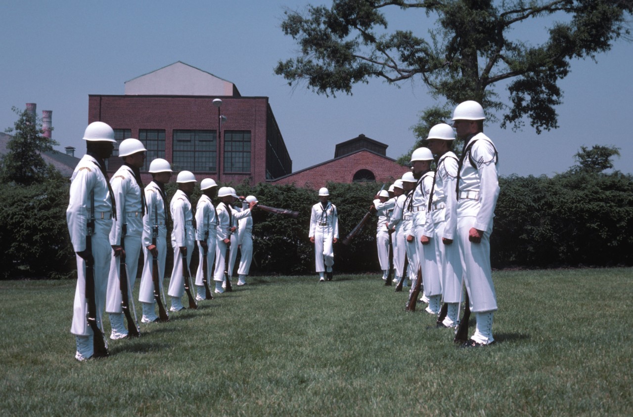 330-CFD-DN-ST-84-00585:  Leutze Park, Washington Navy Yard, 1984.   Members of the Ceremonial Guard Drill Team perform practice drills at their Washington Navy Yard headquarters.  Official U.S. Navy Photograph, now in the collections of the National Archives