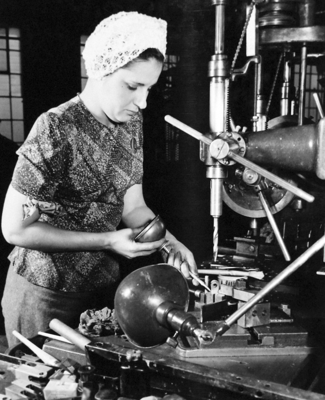 80-G-38498:  U.S. Naval Gun Factory, Washington Navy Yard, 1943.  Shown:  Female employee preparing to drill accurately located hole in a small naval gun detail.  Photograph released March 20, 1943.   Official U.S. Navy photograph, now in the collections of the National Archives.  