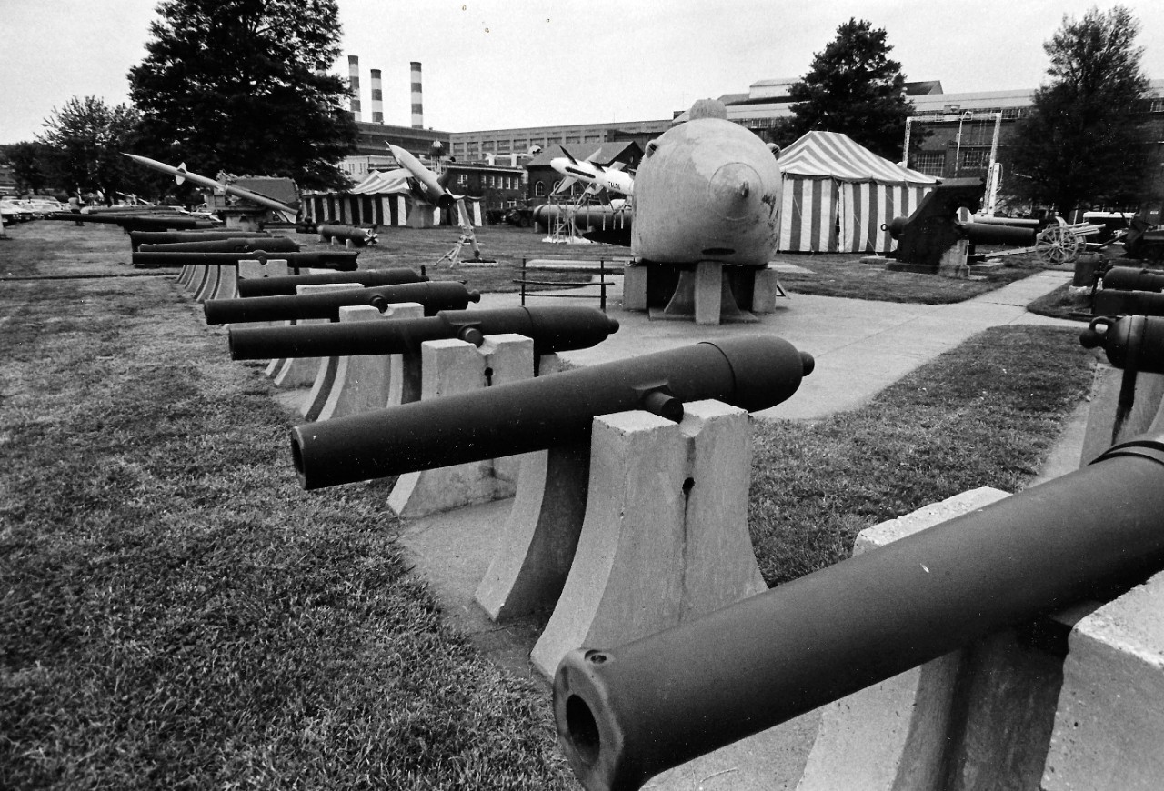 NMUSN-145:   Willard Park, Washington Navy Yard, Washington, D.C, 1970s.    View faces north, showing a variety of guns, along with the submersible Intelligent Whale in the center.   Behind the submersible:  Talos Missile, Regulus II missile, and Japanese two man submarine, circa WWII.    National Museum of the U.S. Navy Photograph Collection.  