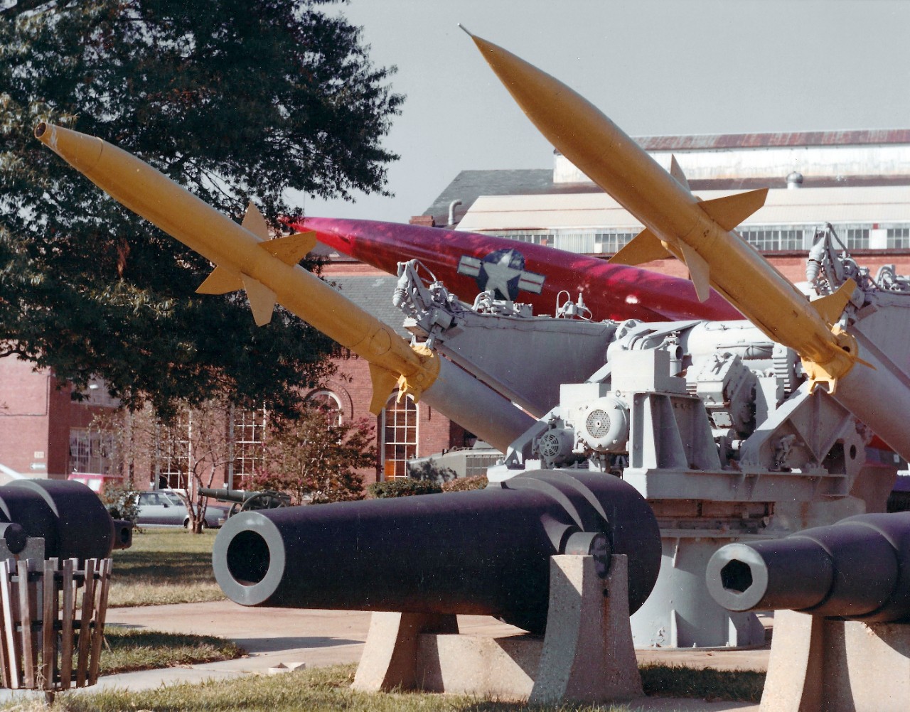 NMUSN-151:  Willard Park, Washington Navy Yard, Washington, D.C. late 1970s.    View looking north.     Terrier Missile (Surface to Air Missiles and Launcher); and Regulus II missile beyond the smooth-bore guns.    National Museum of the U.S. Navy Photograph Collection.  