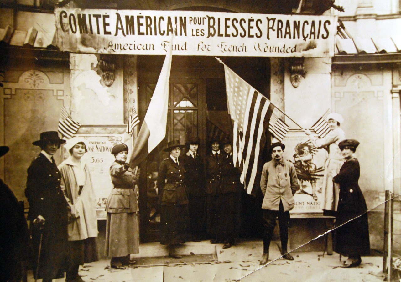<p>165-WGZ-2L-2: Entrance to the American Fund for French Wounded, Paris Depot, located at Alcazar d’Ete, Champs-Elysees, 1918. Note, the French and U.S. Flags, along with Red Cross and probably U.S. Army Nurses. U.S. War Department photograph, now in the collections of the National Archives. (2014/8/27).</p>
