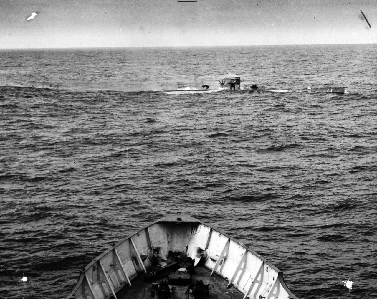 26-G-1513:  Sinking of German submarine U-175, April 1943.   The submarine was sunk off south-west of Ireland by USCGC Spencer (WPG-36) on April 17, 1943.    Original caption, “COAST GUARD CUTTER SINKS SUB: Heaved up from below by the force of a depth charge, the Nazi U-Boat breaks surface as the U.S. Coast Guard Cutter USCGC SPENCER (WPG-36), guns ablaze, bears down on it, full speed ahead." Date: 17 April 1943 (Note on the back of the photo notes: "Not to be released for publication or announced to the public before 10:00 A.M. Eastern War-Time, June 2nd.")  Photo No.: 1513 Official U.S. Coast Guard Photograph, now in the collections of the National Archives.  (2017/09/05).