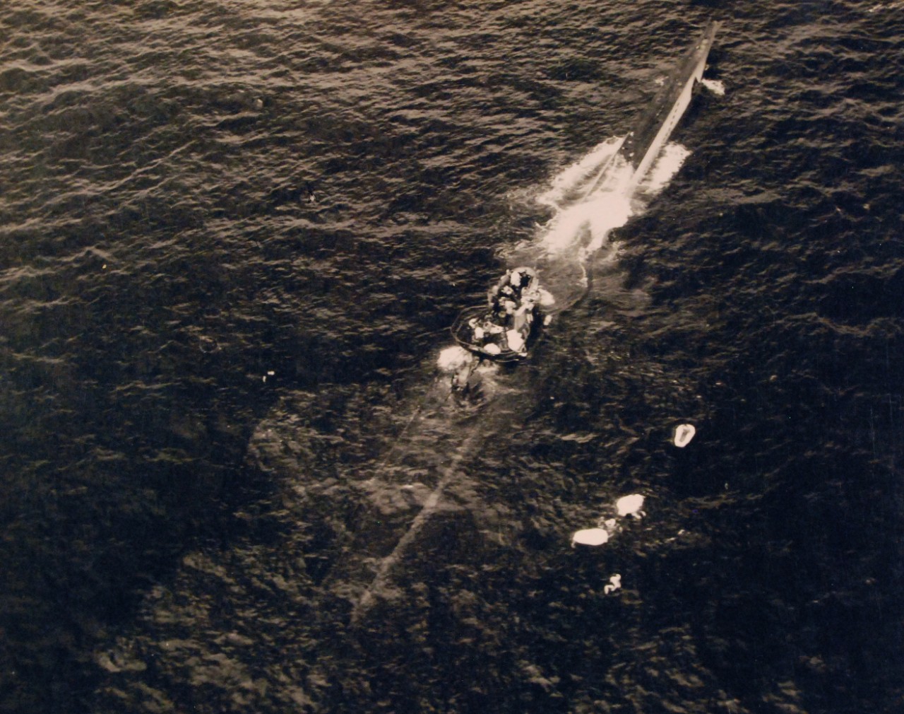 <p>80-G-79389: Air Attacks on German U-boats, WWII. German U-boat incident #3992, August 9, 1943. German submarine, U-664, sinking after an attack by Lieutenant Junior Grade G.G. Hogan, USNR. Forty-four survivors were picked up and taken on board USS Card (CVE-11). Note the German sailors on conning tower.&nbsp;</p>
