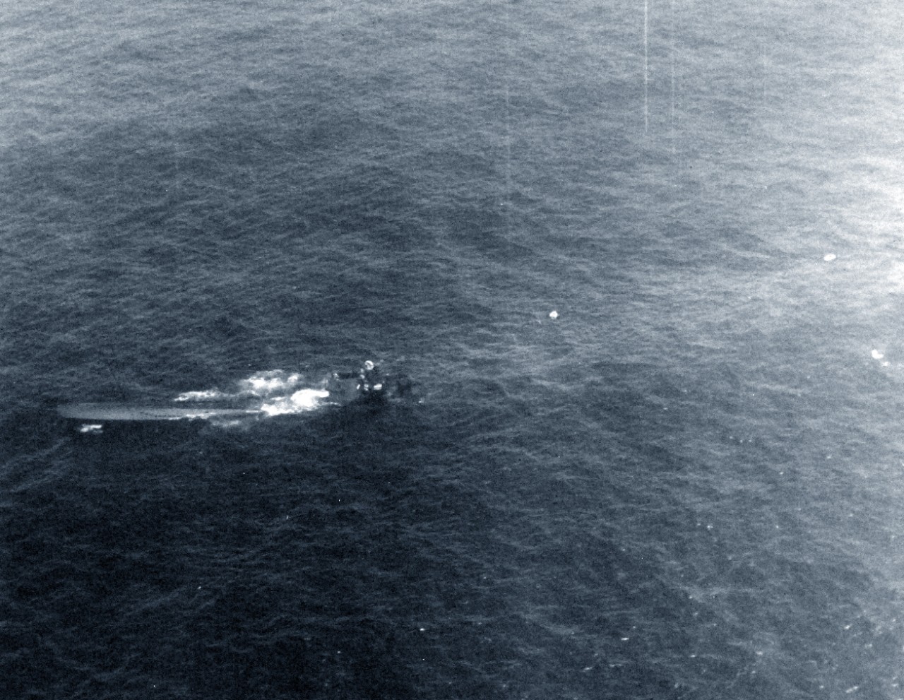 <p>80-G-79408: Air Attacks on German U-boats, WWII. German U-boat incident #3992, August 9, 1943. German submarine, U-664, sinking after an attack by Lieutenant Junior Grade G.G. Hogan, USNR. Forty-four survivors were picked up and taken on board USS Card (CVE-11). This view was taken by another aircraft during the attack.&nbsp;</p>
