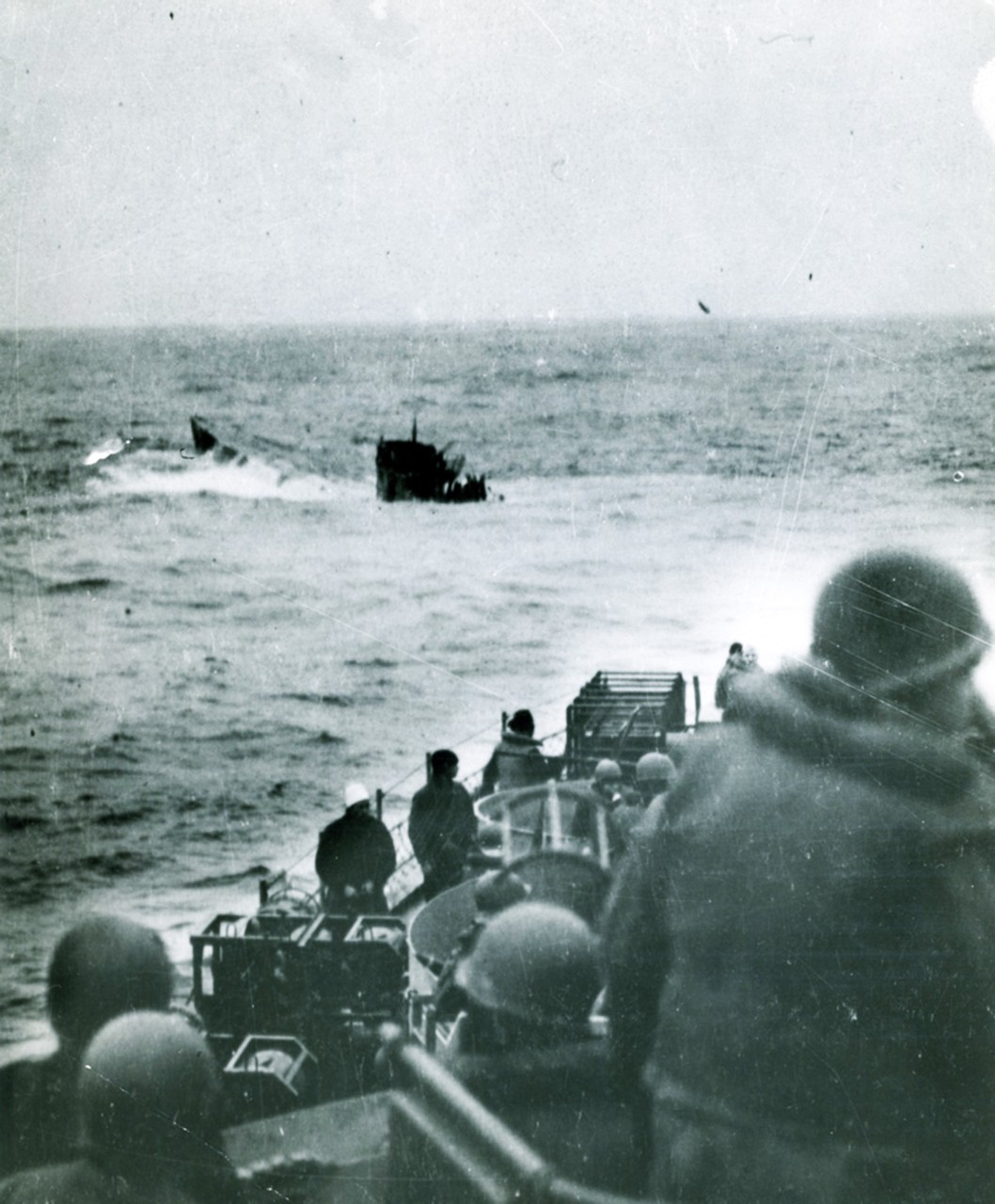 26-G-2552-1:   Sinking of German U-boats, 1944.    German (Type IXC) U-boat, U-550, surfaces astern of USS Joyce (DE 317) after being depth charged, April 16, 1944.  Joyce had a Coast Guard crew.  U.S. Coast Guard photograph now in the collections of the National Archives, 26-G-2552 (Cropped). 