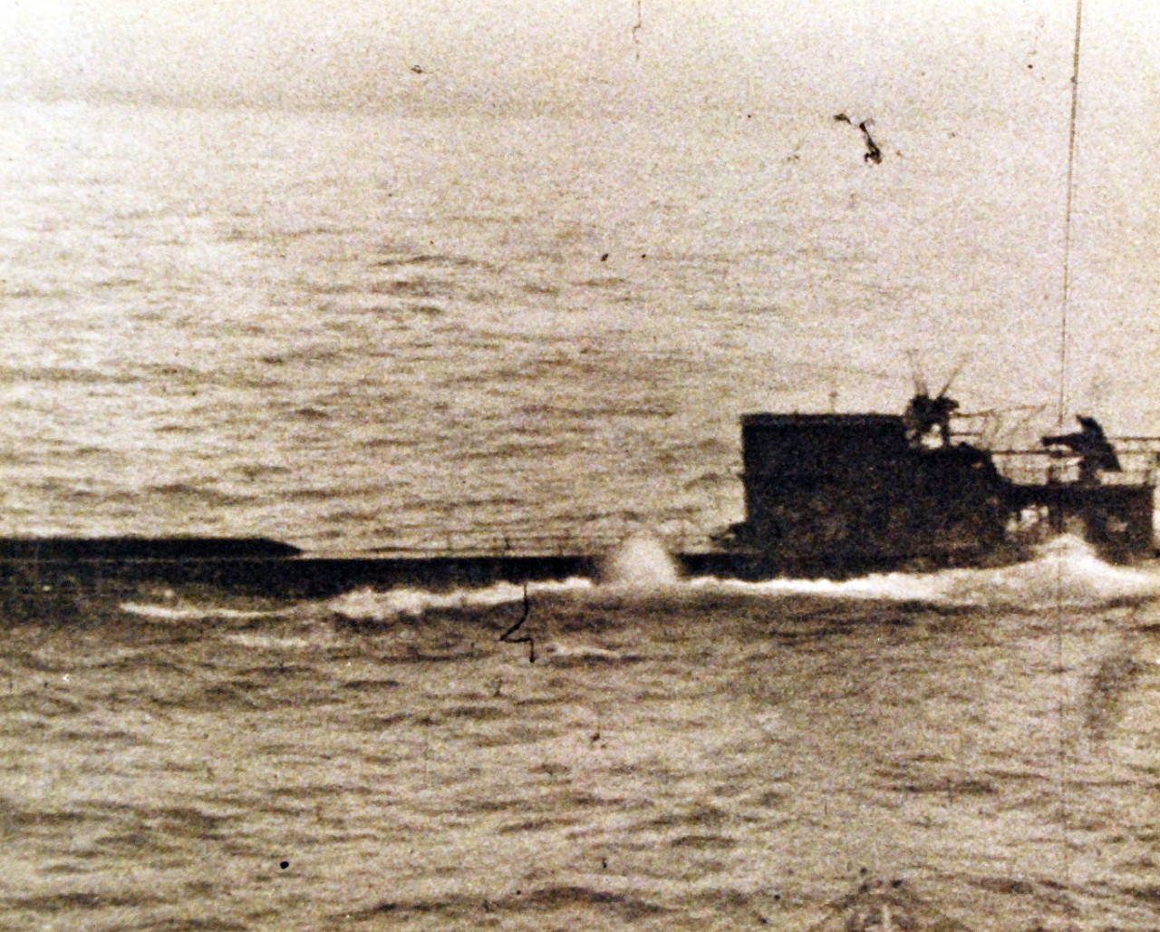 <p>80-G-700006: Battle of the Atlantic. U-233 (German Type XB Submarine) about to be rammed by USS Thomas (DE 102) in the North Atlantic, 5 July 1944. Photographed from Thomas’ bridge, as she approaches to ram the submarine amidships. Note “hump” of mine chutes on U-233’s foredeck, a feature of the type XB boats.&nbsp;</p>
