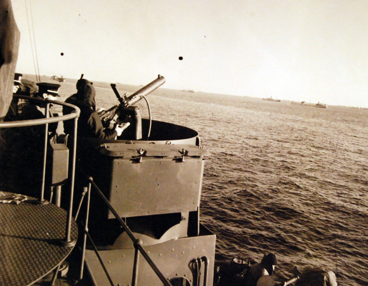 <p>80-G-405293: Merchant Ships: Naval Armed Guard. Crew man anti-aircraft guns as convoy reach dangerous waters. Note the ships of the convoy dotting the horizon, December 1941. Official U.S. Navy Photograph, now in the collections of the National Archives. (2015/9/9).</p>
