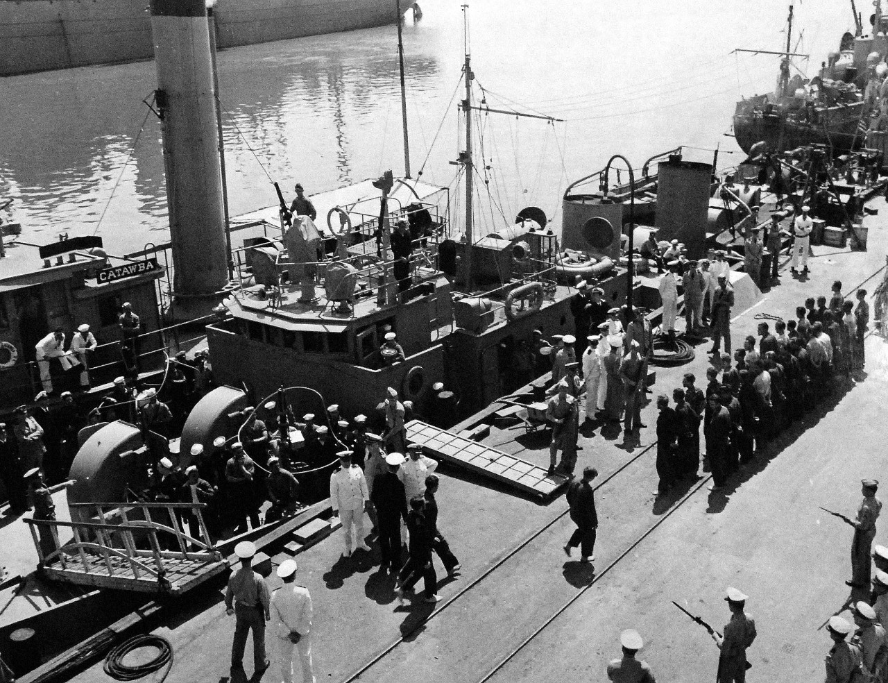 80-G-41302:  German U-boat, U-352, May 1942.    33 German prisoners were brought ashore at the Navy Yard, Charleston, South Carolina, by US Coast Guard cutter Icarus (WPC-110) after sinking of German submarine, U-352, off the Atlantic coast on 9 May 1942.   US Marines, with fixed bayonets stand guard as prisoners are lined up in front of the Coast Guard cutter.  Photograph released 2 May 1943.  Official U.S. Navy Photograph, now in the collections of the National Archives.  (2014/6/12).