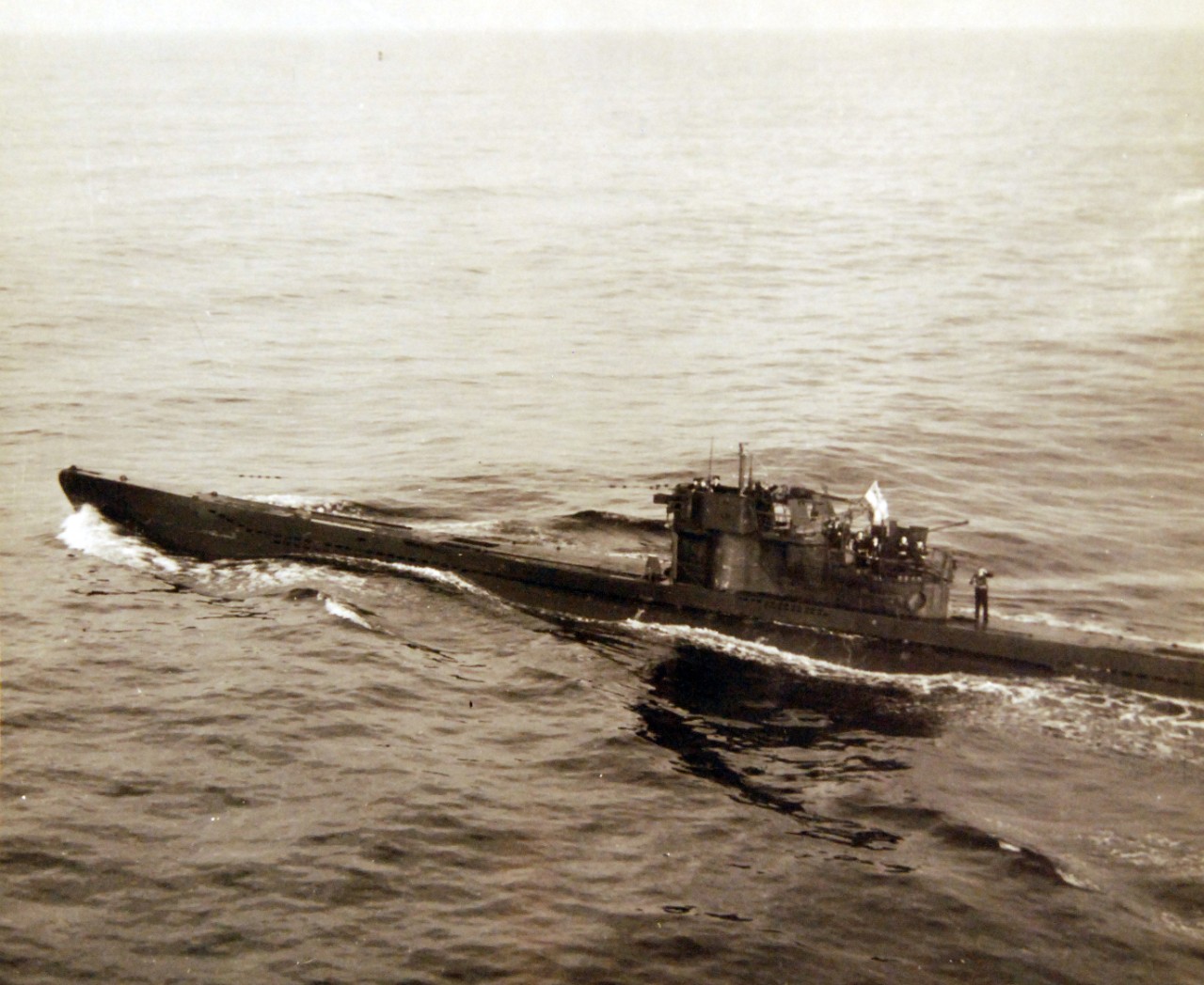 80-G-320287: Surrender of German U-boats, WWII.  U-249 surrendering on May 9, 1945.   U-249 was the first U-boat to surrender after Germany’s surrender.   The submarine surrendered to a PB4Y-1 “Liberator” from FAW-7 off Scilly Islands.  Official U.S. Navy photograph, now in the collections of the National Archives.  (2017/07/18).