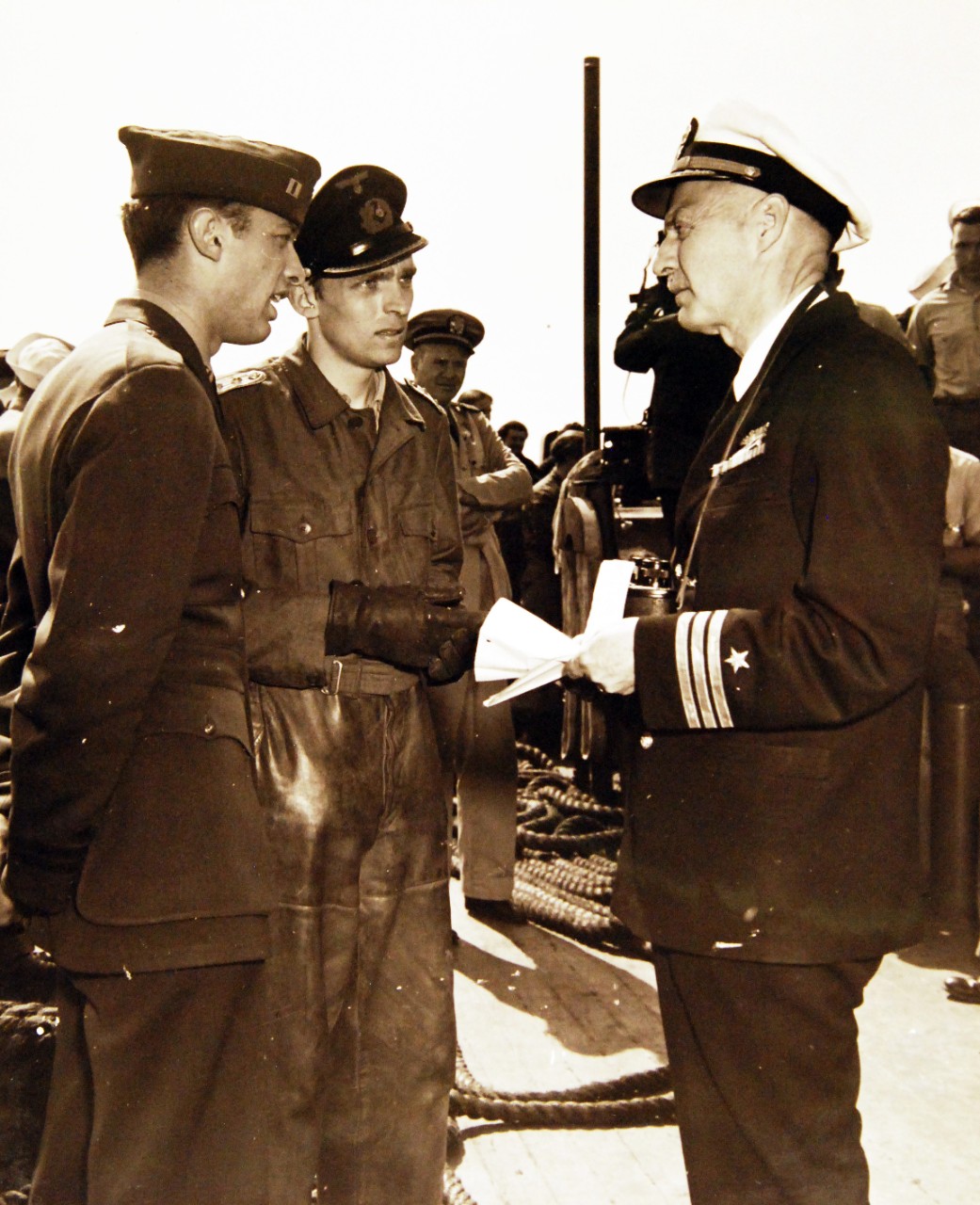 80-G-320315: Surrender of German U-boats, WWII.  Surrender of German U-boat, U-858, 700 miles off the New England Coast to two destroyer escorts, May 10, 1945.  Shown:  Commander J. P. Norfleet, USN, (Retired), right, accepts the surrender of the U-boat Captain, Kapitanleutnant Thilo Bode.  At left is Lieutenant Robert H. Braun, USNR.    Official U.S. Navy Photograph, now in the collections of the National Archives.  (2017/07/18).