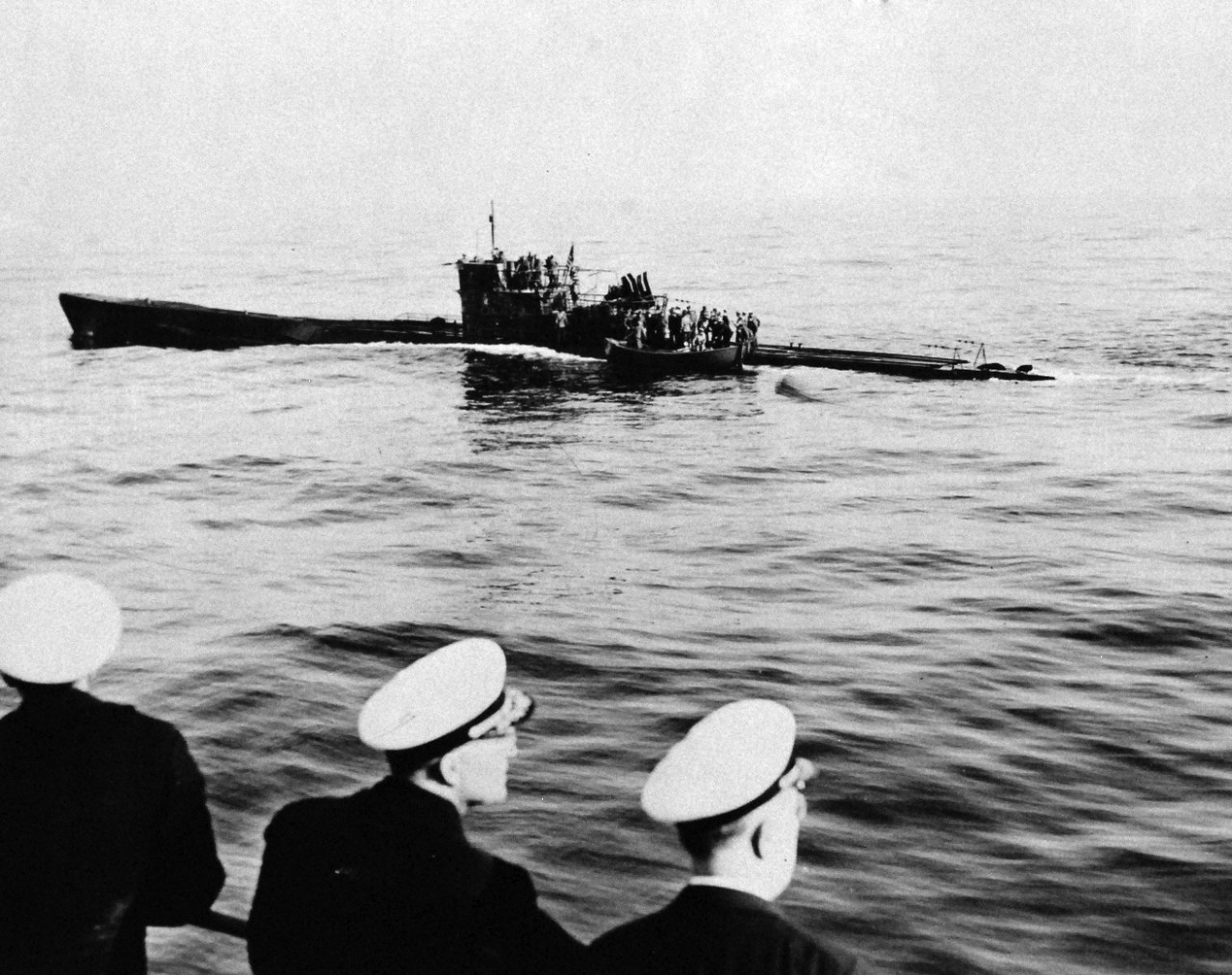 <p>80-G-700486: Surrender of German U-Boats, 1945. U.S. Marines search members of German submarine, U-858, 50 miles off Cape May, New Jersey, May 1945, as the submarine is turned over to representatives of Rear Admiral Milo F. Braemel, Commandant of the Fourth Naval District, by units of the Atlantic Fleet to whom she surrendered. Photograph released May 10, 1945.</p>
