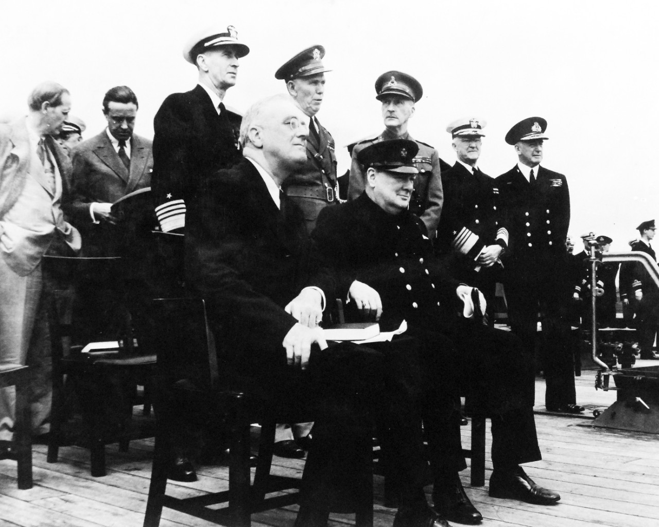 80-G-26850: Atlantic Charter, August 1941.  Informal group on deck of Royal Navy battleship HMS Prince of Wales following church services during the Atlantic Charter meeting.   Standing, left to right:  Harry Hopkins; Averill Harriman; Admiral Ernest J. King; General George C. Marshall; General Sir John Dill; Admiral Harold R. Stark; Admiral Sir Dudley Pound.  Seated:  President Franklin D. Roosevelt and Prime Minister Winston S. Churchill.   Photograph released August 10, 1941.   Official U.S. Navy Photograph, now in the collections of the National Archives.  (2016/03/22).
