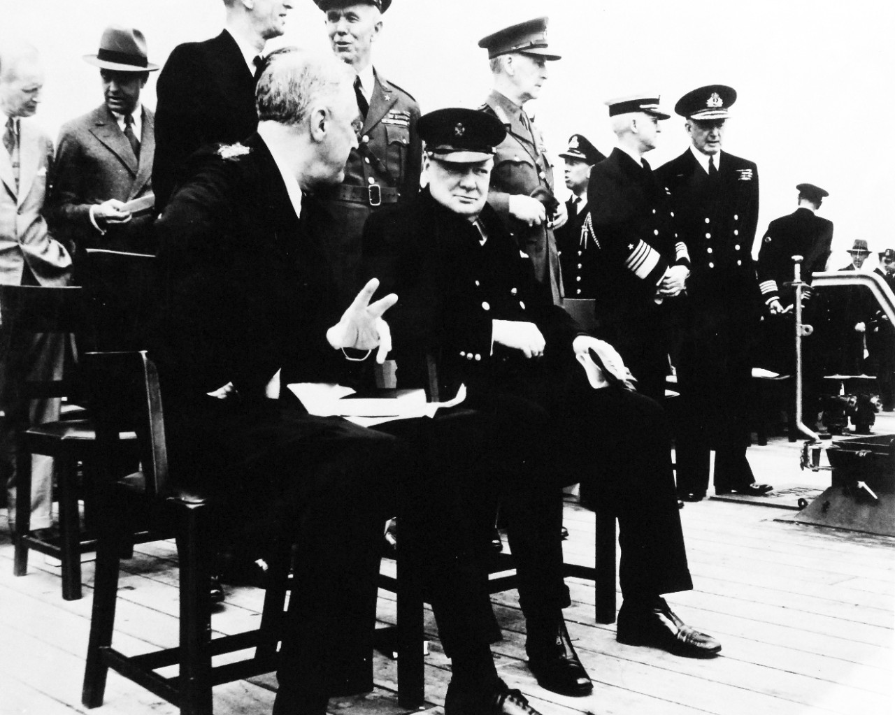 80-G-26860: Atlantic Charter, August 1941.  President Franklin D. Roosevelt and Prime Minister Winston S. Churchill and high-ranking naval and military men of both nations following divine services onboard Royal Navy battleship HMS Prince of Wales during the Atlantic Charter.  Standing left to right:  Harry Hopkins; Averill H. Harriman; Admiral Ernest J. King; General George C. Marshall; Rear Admiral Ross T. McIntire; General Sir John Dill; Captain John R. Beardall; Admiral Harold R. Stark; Admiral Sir Dudley Pound.  Photograph released August 10, 1941.   Official U.S. Navy Photograph, now in the collections of the National Archives.  (2016/03/22).