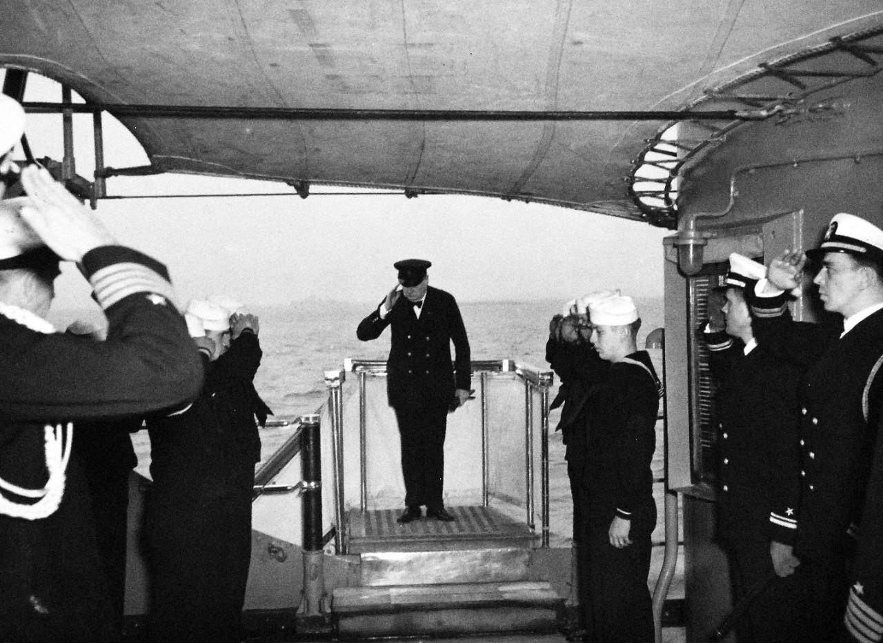 80-G-26869: Atlantic Charter, August 1941.  Prime Minister Churchill arriving on board USS Augusta (CA-31) after a conference with President Roosevelt in the Atlantic Charter meeting.  Prime Minister Churchill saluting the colors.   Photograph released August 1941.   Official U.S. Navy Photograph, now in the collections of the National Archives.  (2016/03/22).