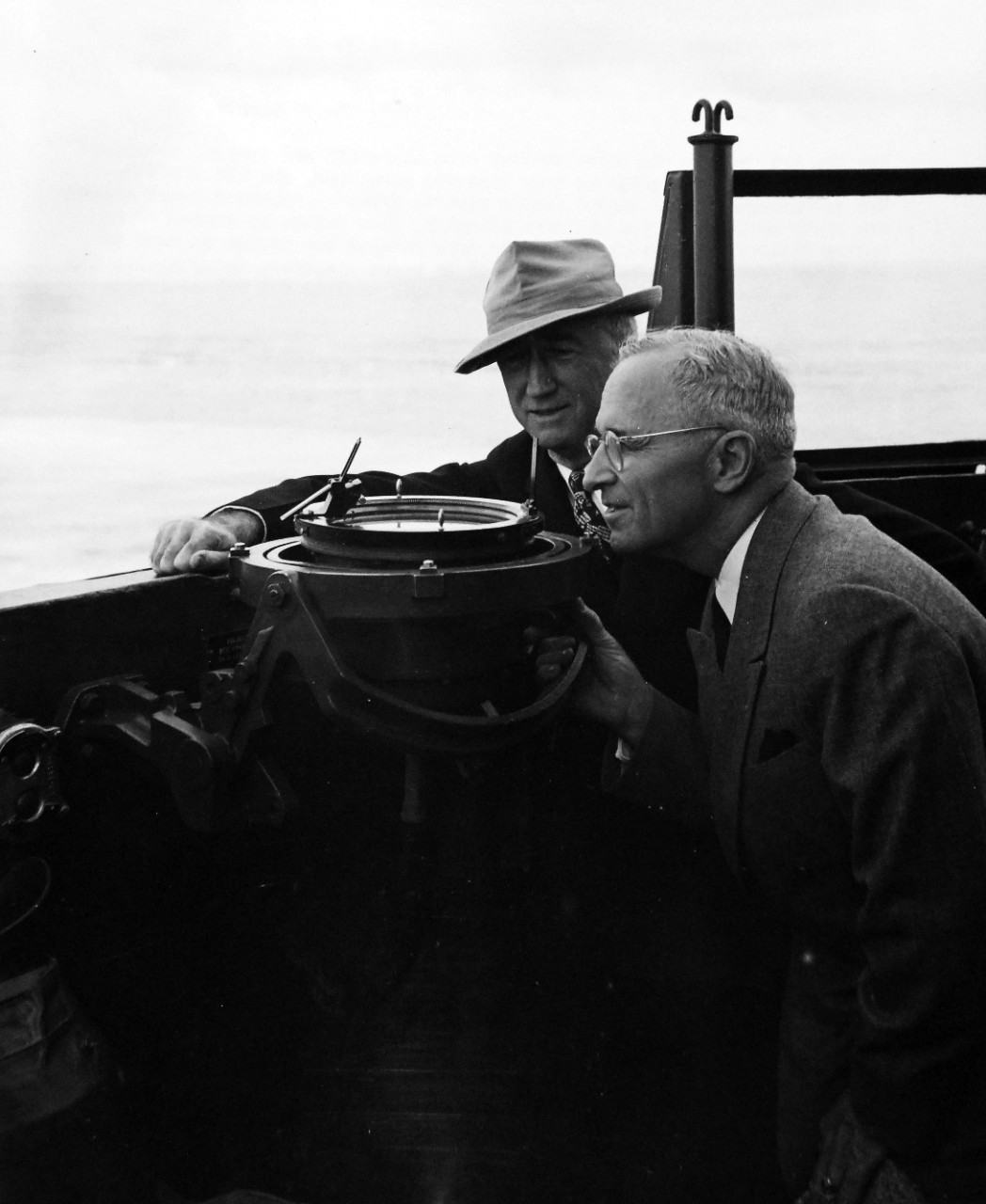 80-G-49924:  Potsdam Conference, July-August 1945.  President Harry S. Truman onboard USS Augusta (CA-31) en-route to Antwerp for the “Big Three” Conference.  Shown:  The President taking a bearing of USS Philadelphia (CL-41) which is ahead of them on the pelorus.  Secretary of State James F. Byrnes is next to the President.    Photograph received July 18, 1945.  Official U.S. Navy Photograph, now in the collections of the National Archives.  (2016/02/23).