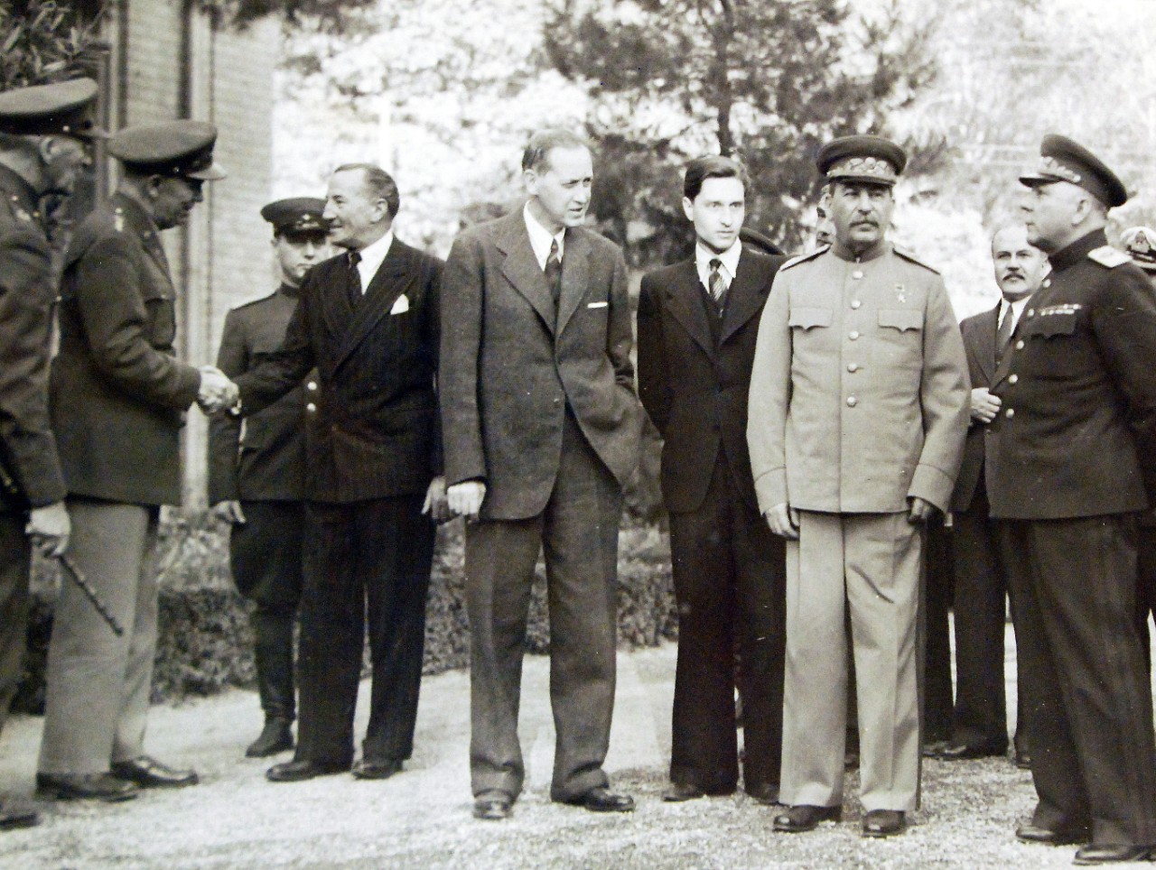 Lot 11597-7:  Tehran Conference, November-December 1943.  Standing outside the Russian Embassy, left to right:  Unidentified British officer; General George C. Marshall, Chief of Staff, USA, shaking hands with Sir Archibald Clark Keer, British Ambassador to the USSR; Harry Hopkins, Marshal Stalin’s interpreter; Marshal Josef Stalin; Foreign minister Molotov; General Voroshilov.  U.S. Army photograph from the collection of the Office of War Information.   Courtesy of the Library of Congress.   (2016/01/15).