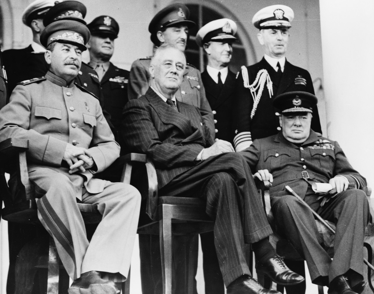 LC-USZ62-91957:   Tehran Conference, November-December 1943.   At the Russian Embassy, Tehran, left to right:  Front row:  Joseph Stalin, President Franklin D. Roosevelt, and Prime Minister Winston S. Churchill.   Back row:  General H.H. Arnold, Chief of the U.S. Army Air Force; unidentified British Officer; Admiral Cunnigham, RN; Admiral William Leahy, USN, Chief of Staff to the President.   U.S. Army Photograph from the collection of the Office of War Information.  Courtesy of the Library of Congress.  