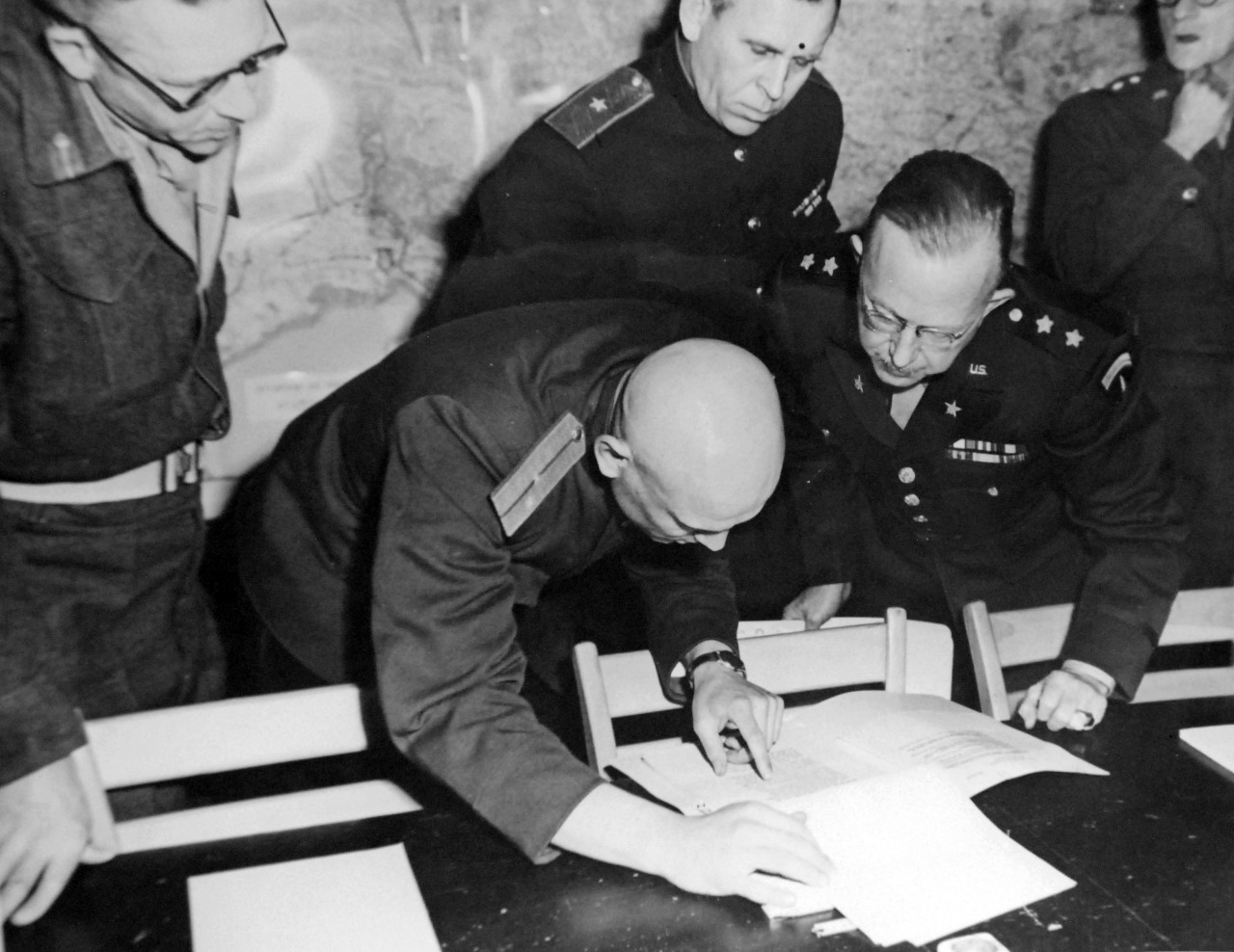 111-SC-27245: Surrender of Germany, 7 May 1945. High Allied Officers check terms of the Unconditional Surrender document during the meeting with representatives of the Doenitz Regime at Supreme Allied Headquarters (SHAEF), Reims, France.  In the picture are Lieutenant General F.E. Morgan, Deputy Chief of Staff, Lieutenant Ivan Cherniaeff, Russian Aide and Interpreter, Major General of Artillery Ivan Alexeyevich Susloparov, and Major General H.R. Bull, G-3, SHAEF.  This photograph is from May 5, 1945.   U.S. Army Photograph. Courtesy of the Library of Congress Collection, Lot-8988. (2015/10/16).
