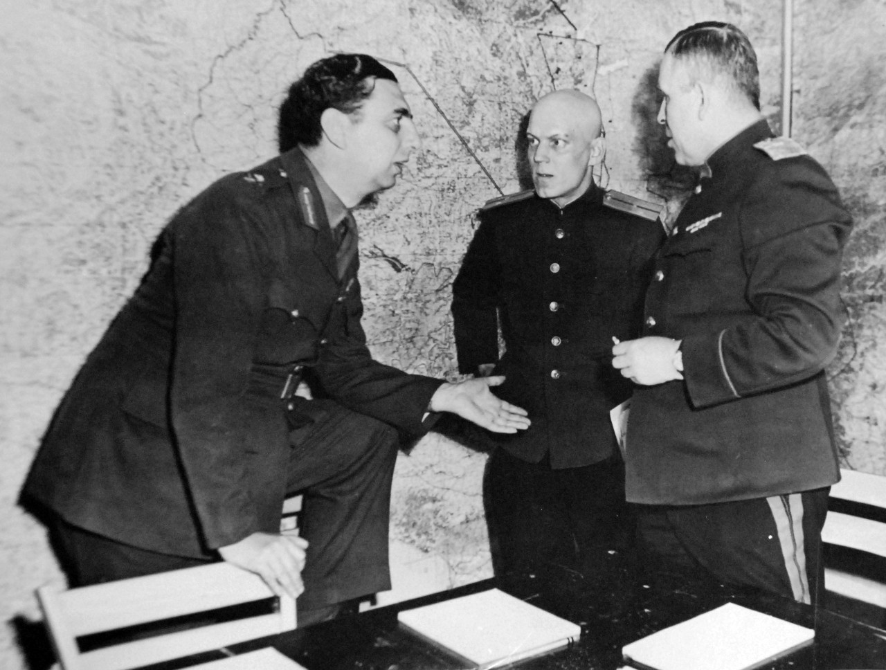 111-SC-27250a: Surrender of Germany, 7 May 1945.  Major General K.W.D. Strong, (left), SHAEF, G-2, discusses reaction of German delegation to unconditional surrender terms given them at SHAEF Forward Headquarters in Reims, France, with the Russian representatives at the event which ended hostilities in Europe.  The Russian officers are, (left to right): Lieutenant Ivan Cherniaeff, Aide and Interpreter, and Major General of Artillery Ivan Alexeyevich Susloparov, who signed the surrender document for the Soviets.   U.S. Army Photograph.  Courtesy of the Library of Congress Collection, Lot-8988. (2015/10/16).