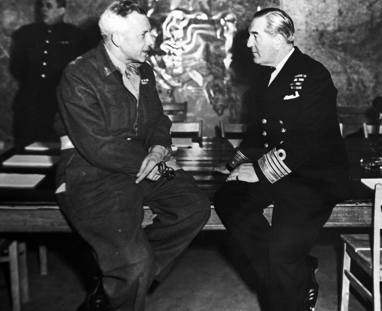 111-SC-27428:   Surrender of Germany, May 7, 1945.  While representatives of the German government discuss unconditional surrender terms in another room, Lieutenant General F.E. Morgan, Deputy Chief of Staff and Admiral Sir Harold M. Burrough, Allied Naval Commander in Chief of Expeditionary Forces, calmly discuss the military decline in Germany in the SHAEF War Room at Reims, France, where the surrender terms were presented, May 5, 1945.  U.S. Army photograph.  Courtesy of the Library of Congress Collection, Lot-8988. (2015/10/16).