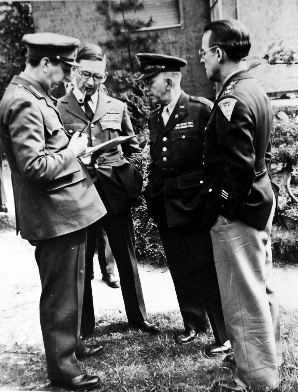 111-SC-27433: Surrender of Germany, 7 May 1945. Studying revised surrender terms at Russian Headquarters are left to right: Major General K.W.D. Strong; Air Chief Marshall Sir Arthur Tedder, Deputy Supreme Commander; Major General H.R. Bull, G-3; and Major General John R. Deane, CG, SHAEF Mission to Moscow, ratifies surrender terms were agreed upon at Reims, France, earlier in the week.  U.S. Army Photograph.  Courtesy of the Library of Congress Collection, Lot-8988. (2015/10/16).