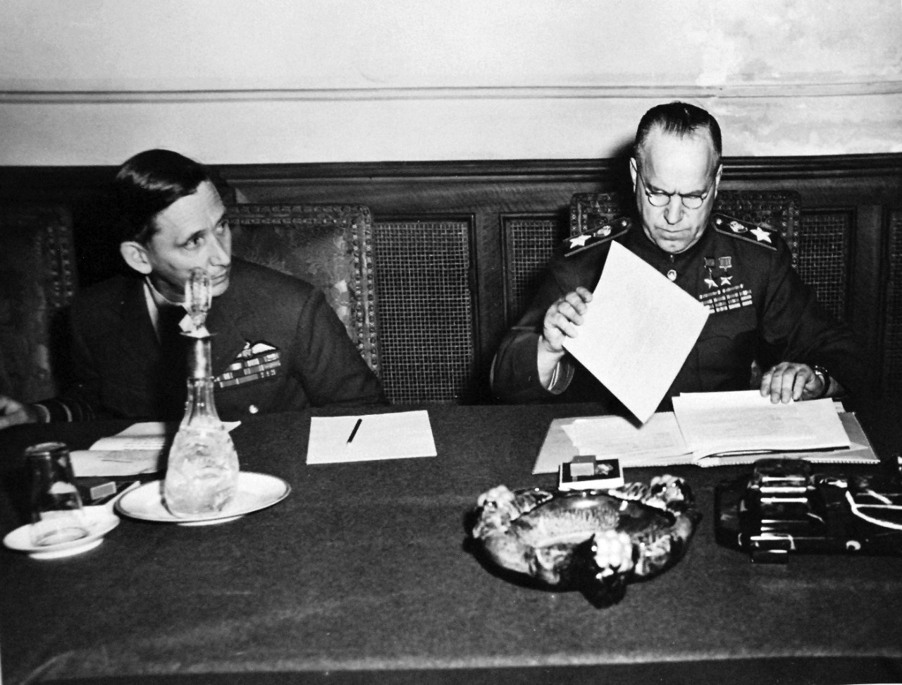111-SC-27436: Surrender of Germany, 7 May 1945.  (Left to Right):  Air Chief Marshall Sir Arthur Tedder, Deputy Supreme Commander and Field Marshall George K. Zhukov, Deputy Commander in Chief of all Soviet forces, examines the ratified terms agreed upon at Reims, France, at Russian Headquarters in Berlin, Germany.  U.S. Army Photograph.  Courtesy of the Library of Congress Collection, Lot-8988. (2015/10/16).