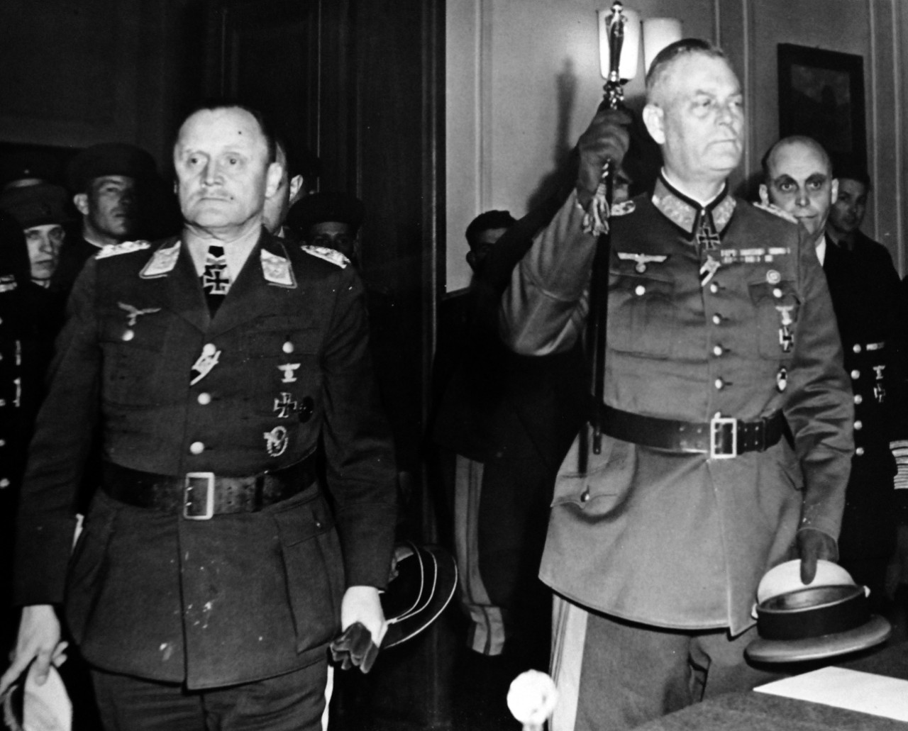 111-SC-27437:   Surrender of Germany, May 9, 1945.  Shown left to right: Field Marshall Wilhelm Keitel, Commander of German Army and Colonel General Hans-Jurgen Stumpff, Chief of the Luftwaffe; and General Admiral Hans Georg Frideburg, Commander of the Germany Navy (rear right); after the trio had completed the signing of the ratified unconditional terms at the Russian Headquarters in Berlin.   Photographed by Lieutenant Moore.   U.S. Army photograph. Courtesy of the Library of Congress Collection, Lot-8988. (2015/10/16).