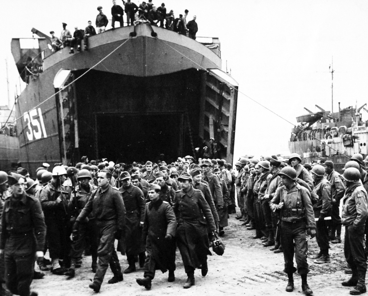 80-G-54415:   Battle of Anzio, January-June 1944.   German Prisoners at the Anzio Beachhead below Rome, on their way to prison camp.  Note USS LST 351. Photograph released February 17, 1944.  Official U.S. Navy photograph, now in the collections of the National Archives.  (2016/06/28).