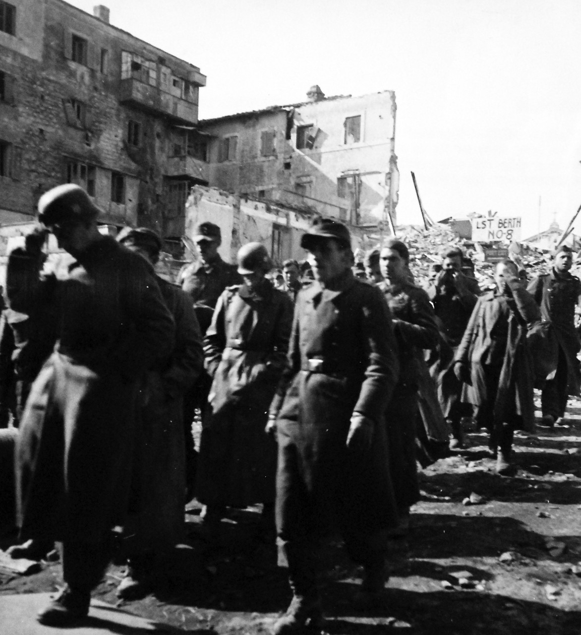 80-G-58428:  Battle of Anzio, January-June 1944.   German prisoners at Anzio, Italy.  Captured in struggle for beachhead below Rome, German soldiers march down to a ship for transportation to a behind the lines prison camp.      Photographed March 4 1944.  Official U.S. Navy photograph, now in the collections of the National Archives.  (2016/06/28).