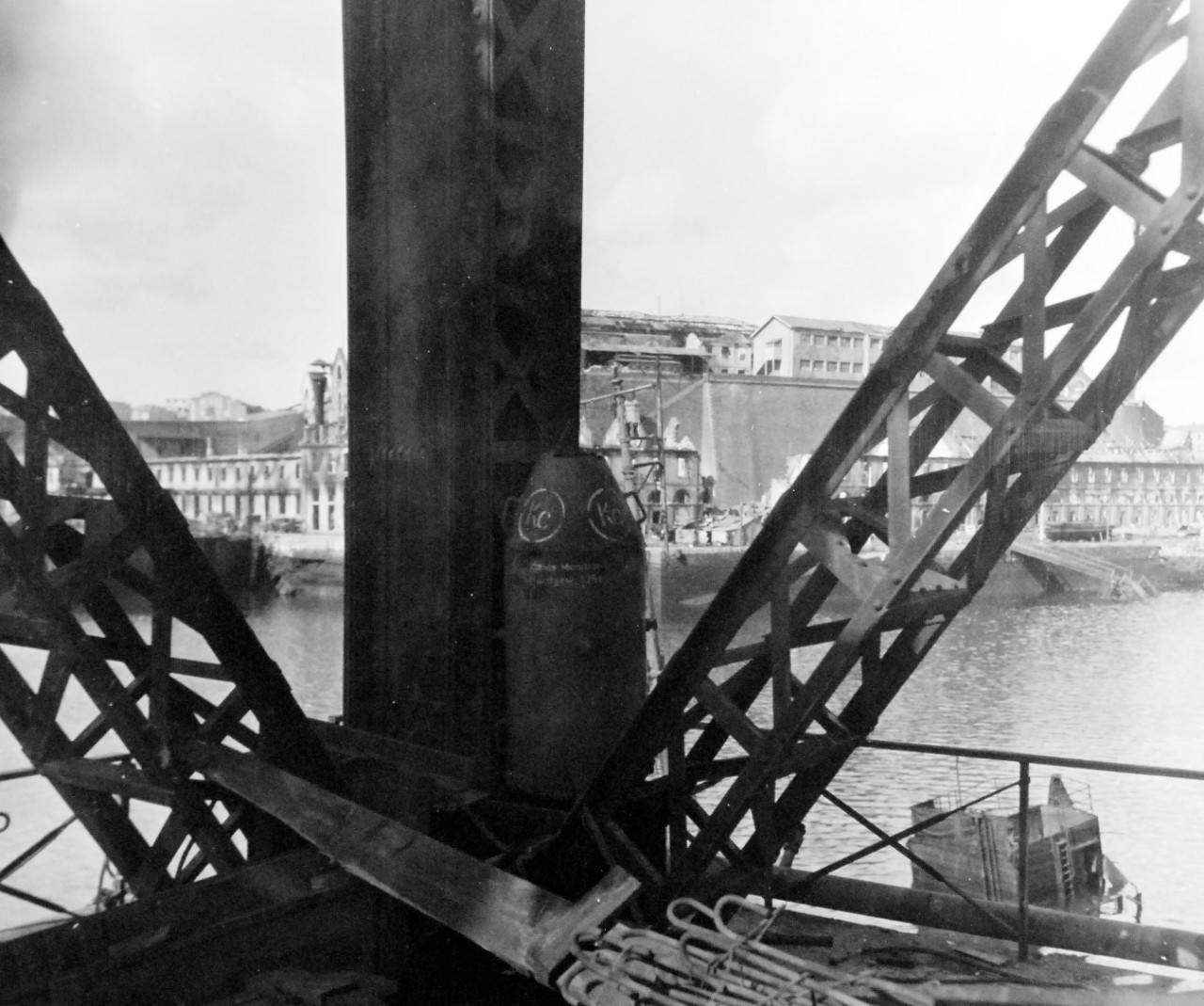 80-G-257428:  Invasion of Southern France, Brest, August-September 1944.   A German mine placed in the leg of 150 ton crane on the waterfront at Brest, France, apparently the garrison surrendered before it had time to detonate it.  Wreckage in background from allied bombing, 27 September 1944.  Official U.S. Navy Photograph, now in the collections of the National Archives.   (2014/10/28).