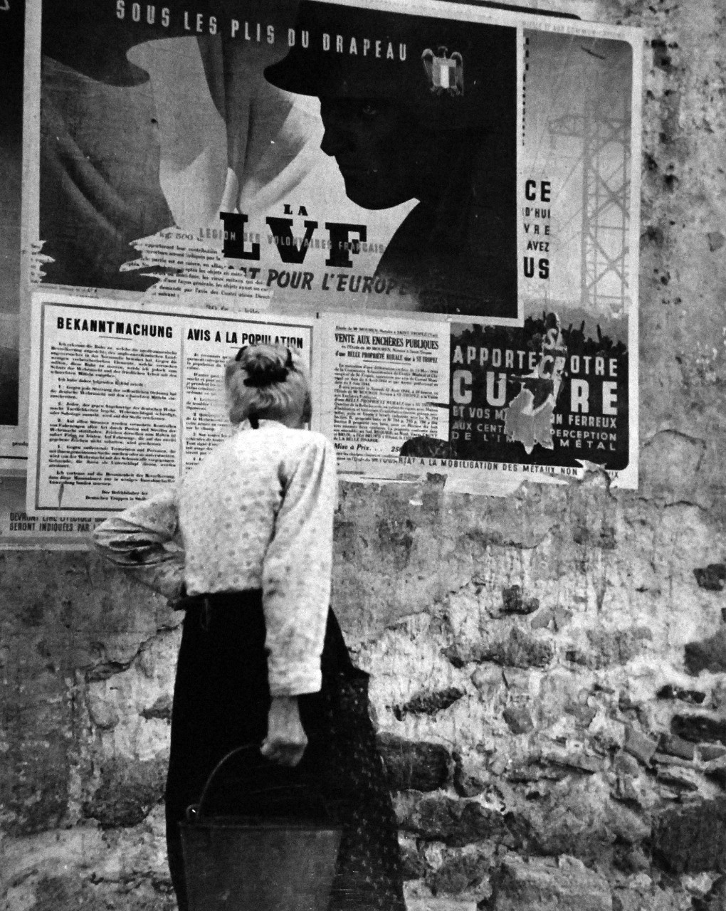 80-G-242117:  Invasion of Southern France, August 1944.     Poster found in southern coastal town in France during invasion, D-Day plus one.  An ancient resident stops to re-read a fading proclamation, posted by Nazi authorities before they were forced to fee.  Photographed by crewmember of USS Catoctin (AGC 5), 16 August 1944.  Official U.S. Navy Photograph, now in the collections of the U.S. Navy.   (2014/5/22).