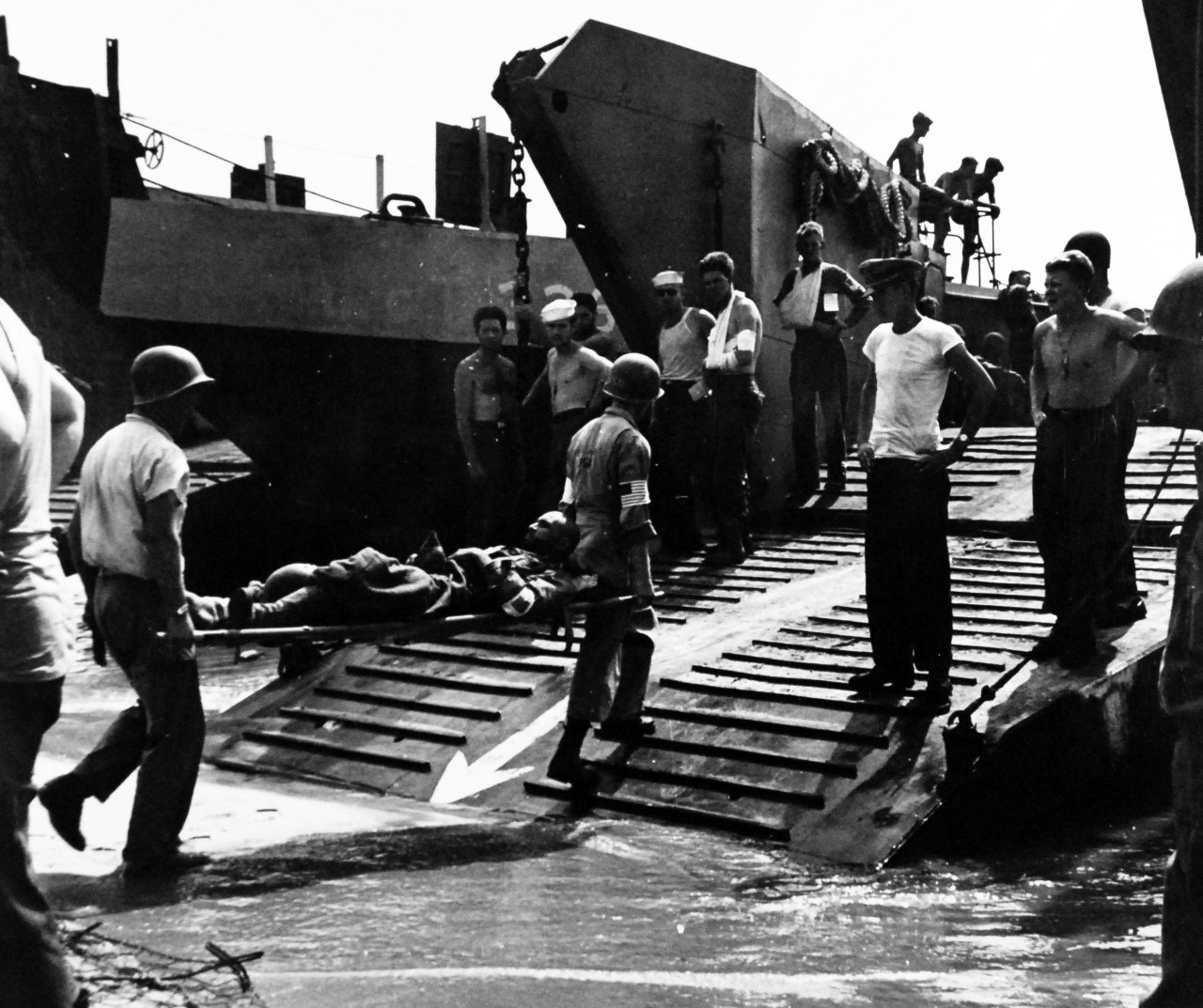 80-G-242119:   Invasion of Southern France, August 1944.     Men wounded in invasion of Southern France are carried onboard landing craft to hospital ships off the coast for treatment and transportation to rear area hospitals. Photographed by crewmember of USS Catoctin (AGC 5), 16 August 1944.  .  Official U.S. Navy Photograph, now in the collections of the U.S. Navy.   (2014/5/22).