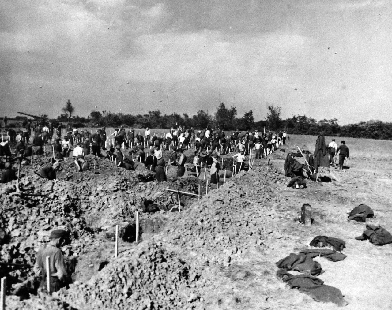 80-G-285229:  Normandy Invasion, German Prisoners, June 1944. German prisoners, captured during invasion of Normandy, France, digging graves overlooking Dog Red beach.   Photograph released November 7, 1944.  U.S. Navy photograph, now in the collections of the National Archives.  (2016/03/15).