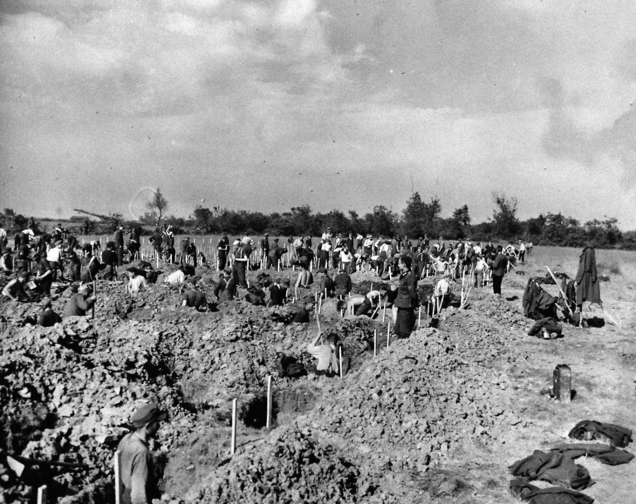 80-G-285230:  Normandy Invasion, German Prisoners, June 1944. German prisoners, captured during invasion of Normandy, France, digging graves overlooking Dog Red beach.   Photograph released November 7, 1944.  U.S. Navy photograph, now in the collections of the National Archives.  (2016/03/15).