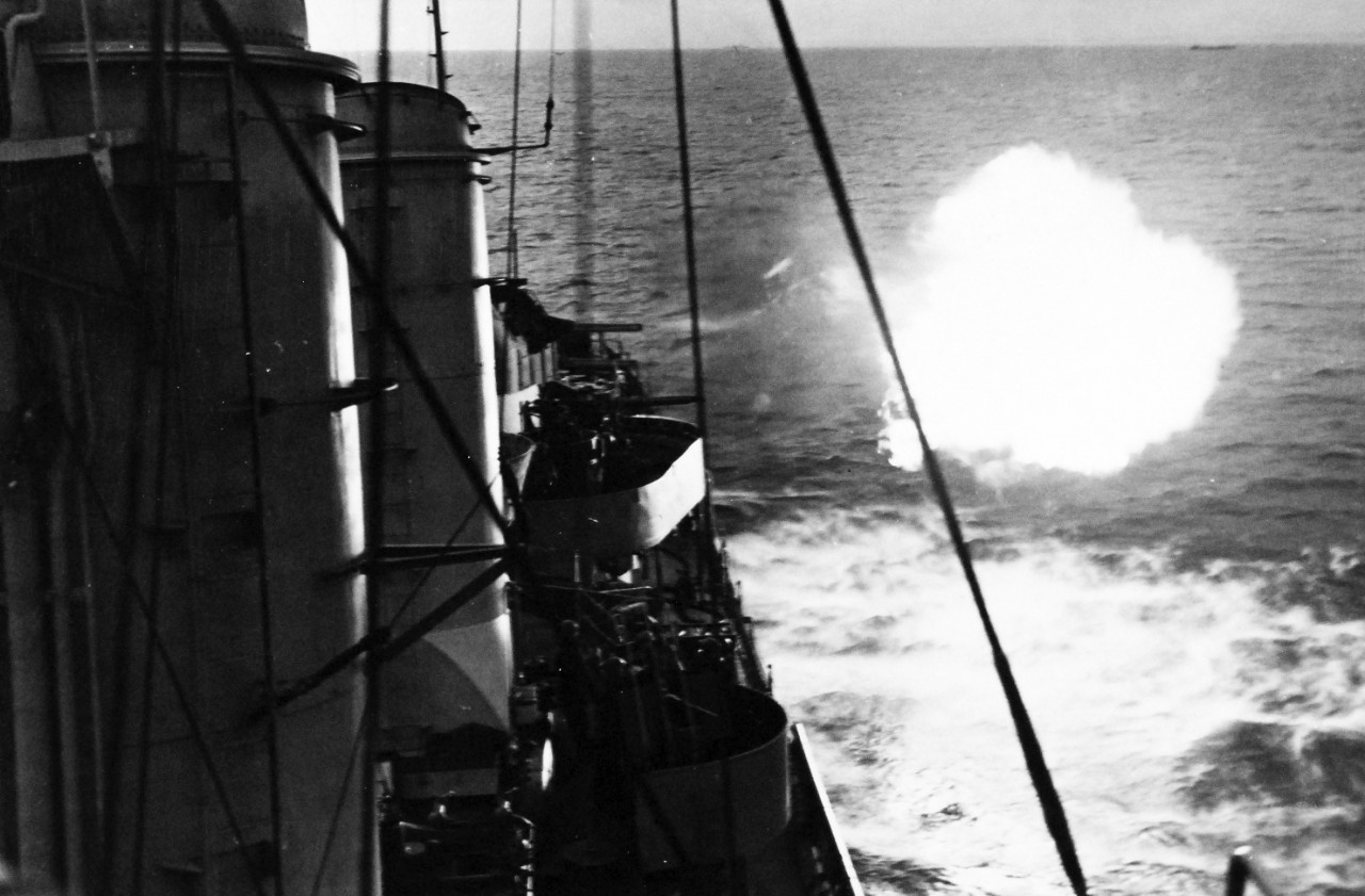 80-G-45697:   Normany Invasion, U.S. Navy Ships, June 1944.     Invasion of France.  Puffs of flame-lit clouds erupt from the guns of U.S. Navy destroyers as the warship bombards the French coast.   Photograph released 8 June 1944.  Official U.S. Navy Photograph, now in the collections of the National Archives.  (2014/9/9).  