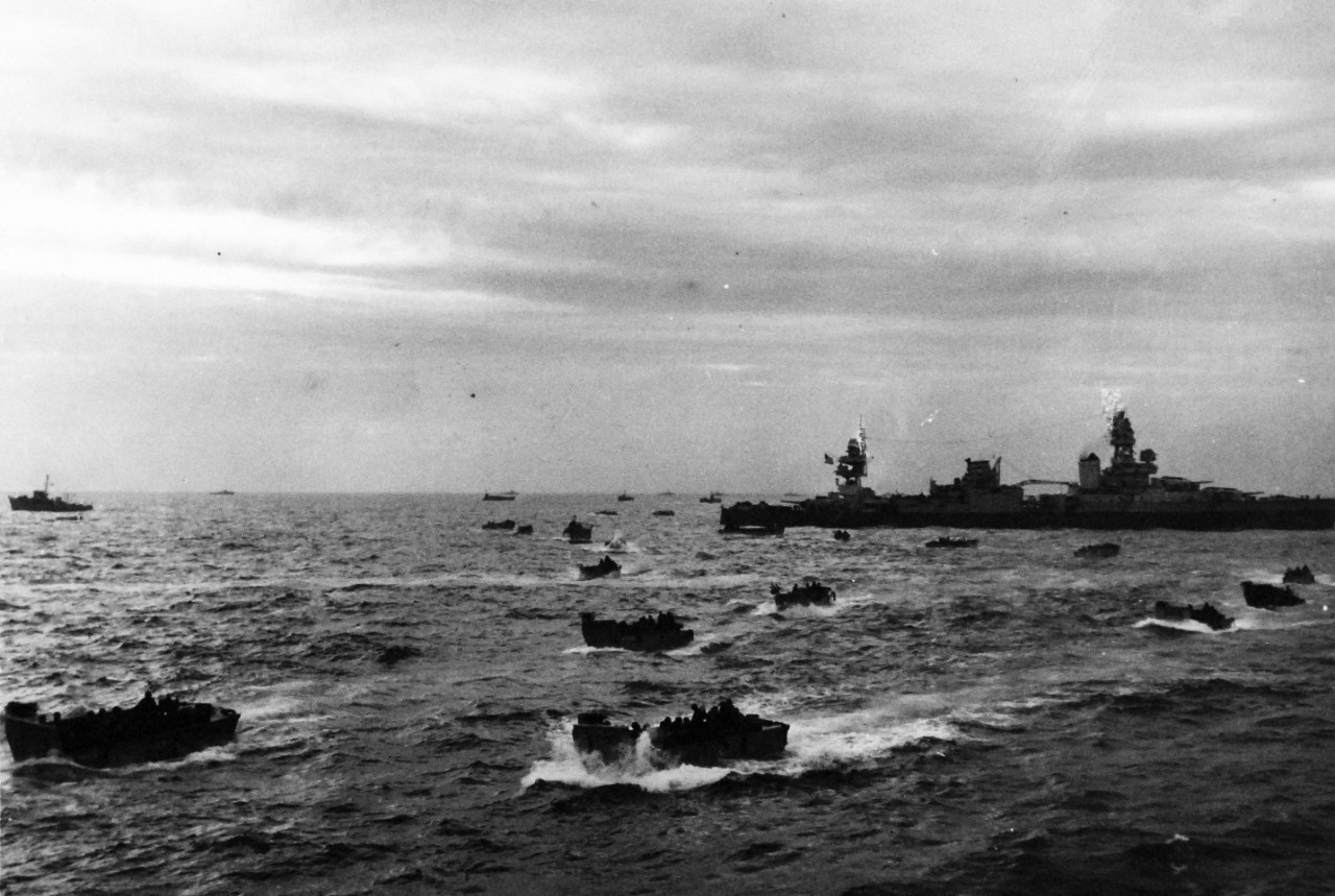 80-G-45720:   USS Augusta (CA-31), U.S. Navy Ships, June 1944.    The cruiser is off French Invasion coast, probably Omaha Beach, during landing operations.  Small landing craft speeding toward shore.  Photographed released 12 June 1944.   Official U.S. Navy Photograph, now in the collections of the National Archives.  (2014/9/9).  