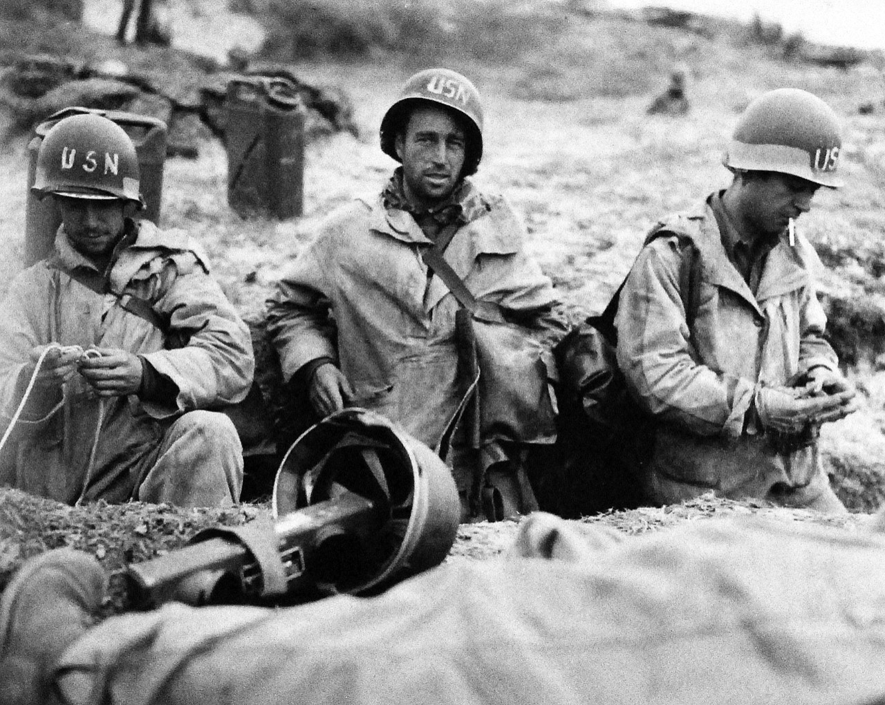 80-G-252732:  Normandy Invasion, Utah Beach, June 1944. Members of the U.S. Navy 2nd Beach Battalion catch a “breather” at their new “home” on the French beach, after hot action on beachhead.  Note, the walkie-talkie in the foreground.  Photograph released 11 June 1944.   Official U.S. Navy Photograph, now in the collections of the National Archives.   (2014/10/28). 