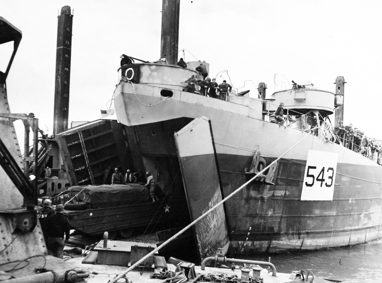80-G-285176:  Normandy Invasion, Mulberries, June 1944.   USS LST-543 is the first landing ship to unload at Loebnitz pier off Normandy coast, France.  The pier is a unit of the U.S. Mulberry, a man-made harbor.  Photograph released November 7, 1944.  Official U.S. Navy photograph, now in the collections of the National Archives.  (2016/03/15).