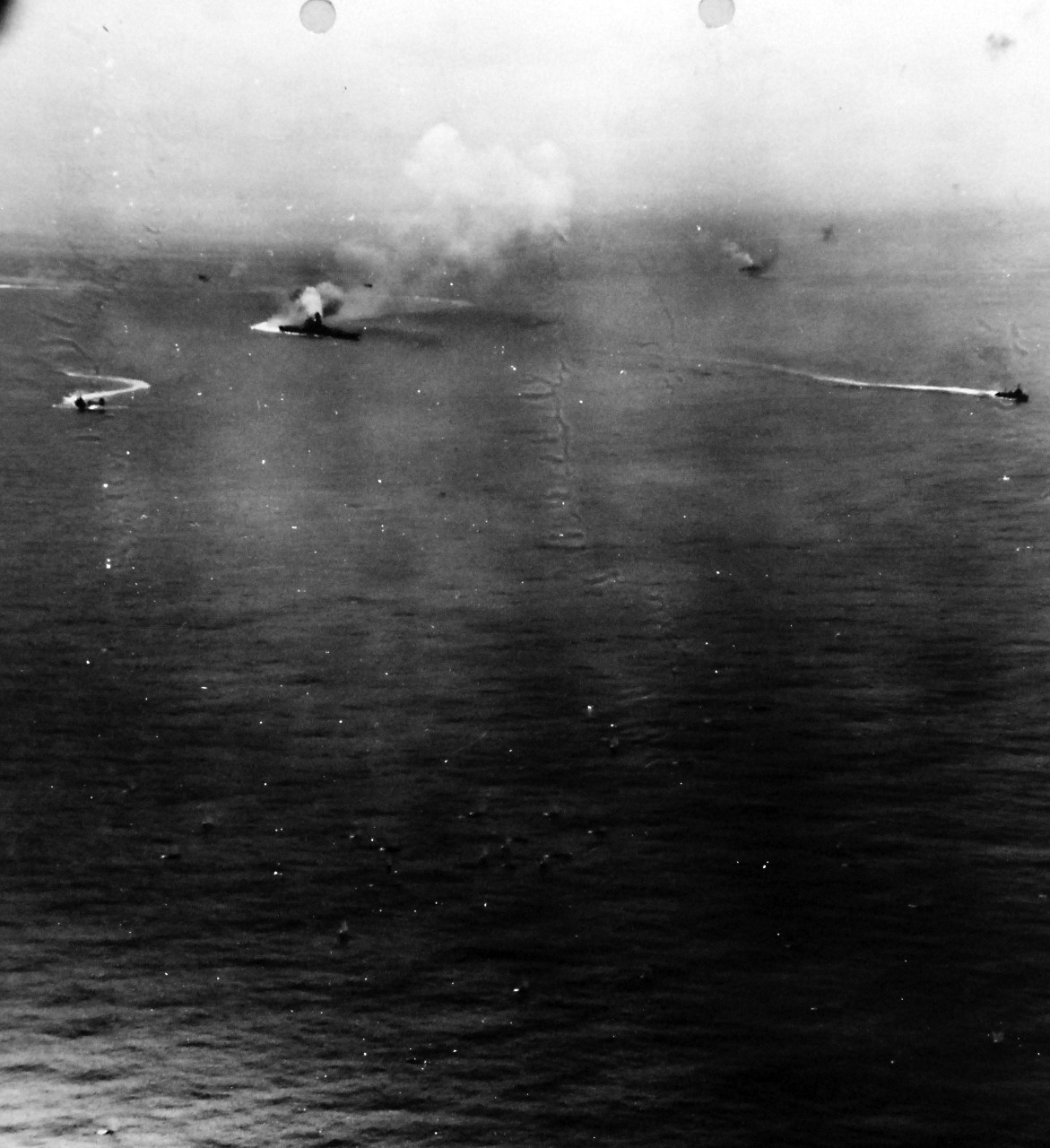 80-G-320641:   Operation Ten-Go,  Japanese battleship Yamato, April  7, 1945.  Japanese battleship Yamato blows up after receiving massive bomb and torpedo damage from U.S. Navy carrier planes, north of Okinawa.   Three Japanese destroyers are nearby.  Photographed by planes from USS Hornet (CV-12).  Official U.S. Navy Photograph, now in the collections of the National Archives. (2016/07/05)