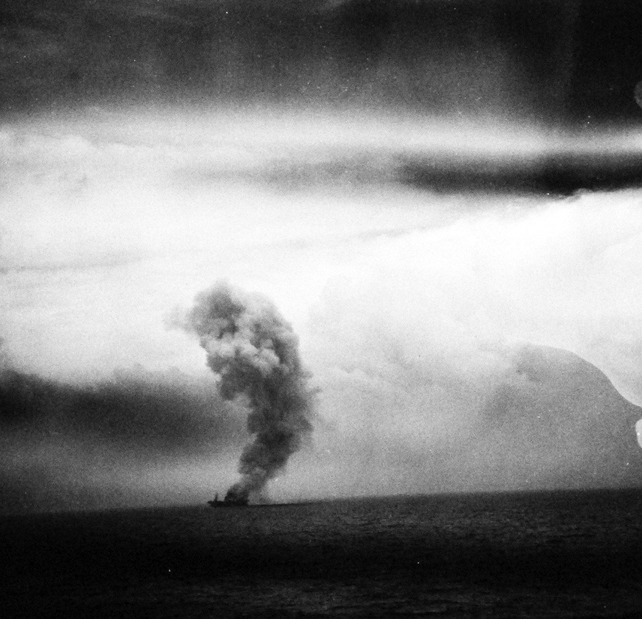 80-G-287510:  USS St. Lo (CVE-63), October 25, 1944.  St. Lo burning after Japanese fighter makes suicide dive onto the flight deck during the Battle of Leyte Gulf.  As seen from USS Kitkun Bay (CVE-71).  Official U.S. Navy photograph, now in the collections of the National Archives.  