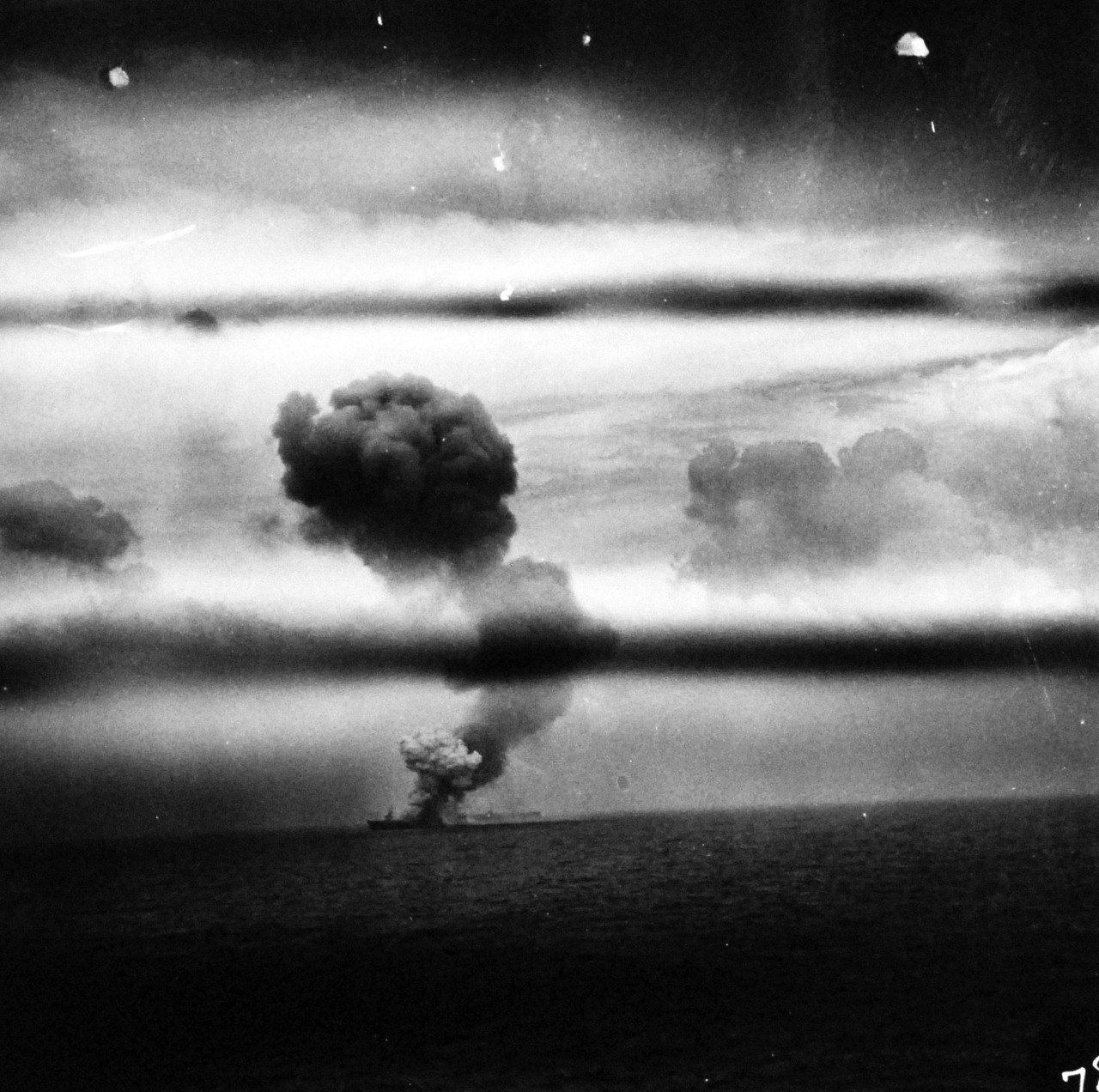 80-G-287511:  USS St. Lo (CVE-63), October 25, 1944.  St. Lo burning after Japanese fighter makes suicide dive onto the flight deck during the Battle of Leyte Gulf.  As seen from USS Kitkun Bay (CVE-71).    Official U.S. Navy photograph, now in the collections of the National Archives.  