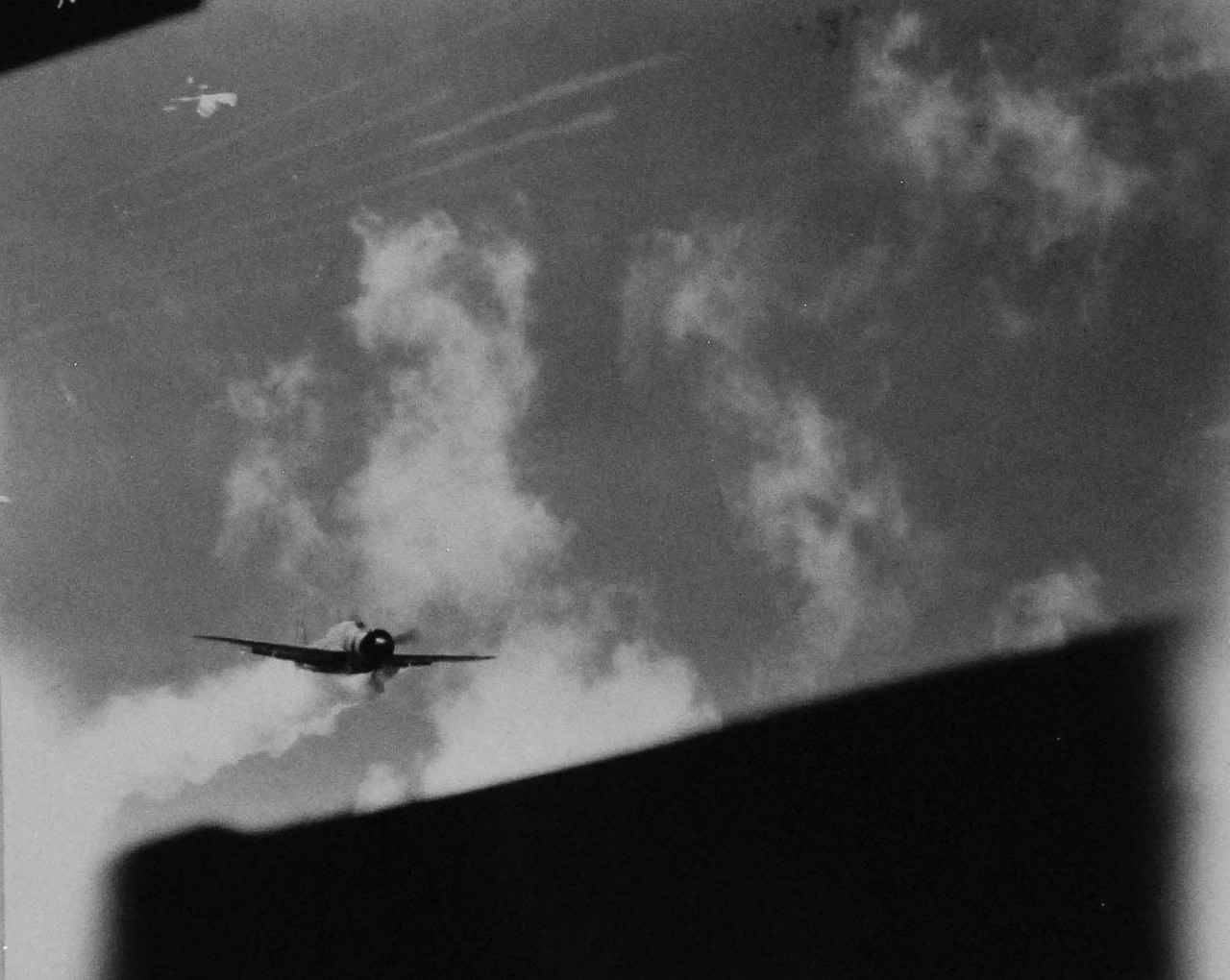 80-G-270648:  USS Essex (CV-9), November 25, 1944.  Japanese Yokosuka D4Y “Judy” making a kamikaze dive on USS Essex (CV-9), off the Philippines.  Photographed from Essex.   This plane struck near the forward elevator.    Official U.S. Navy photograph, now in the collections of the National Archives.    