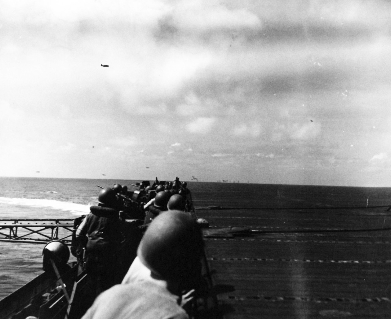 80-G-270824:  USS Intrepid (CV-11), November 25, 1944.   The aircraft carrier goes into evasion turn as Japanese plane starts low level attack. Official U.S. Navy photograph, now in the collections of the National Archives.    