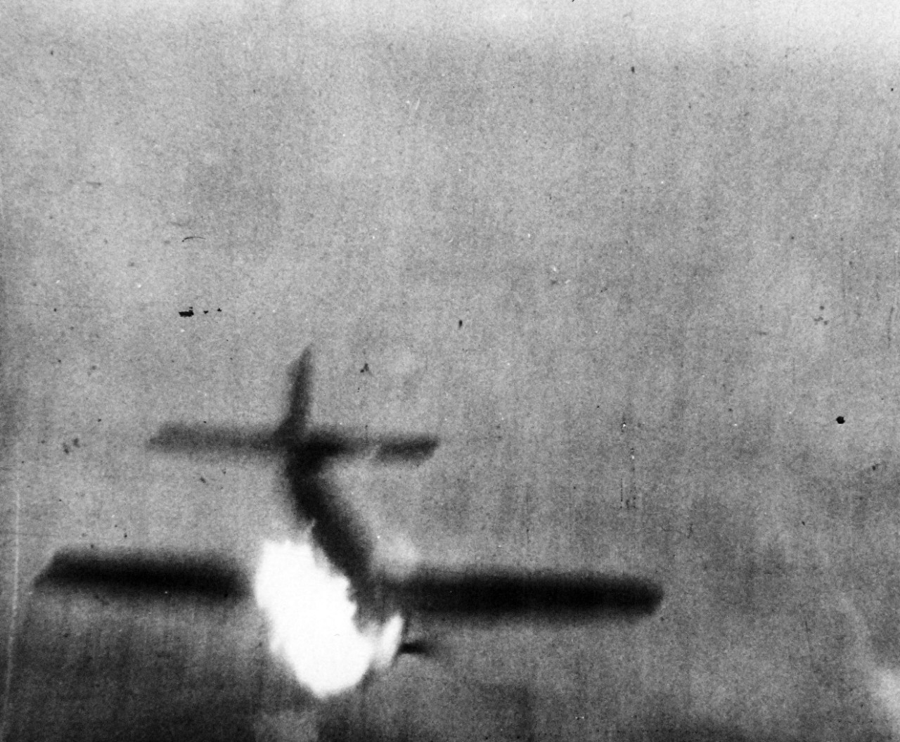 80-G-49706:  Japanese Kamikaze Attack, June 1945.  Flames stream out from a Japanese Kamikaze as it is hit by anti-aircraft fire in its futile attempt to crash against the carrier.  Released June 28, 1945.   Official U.S. Navy photograph, now in the collections of the National Archives.  