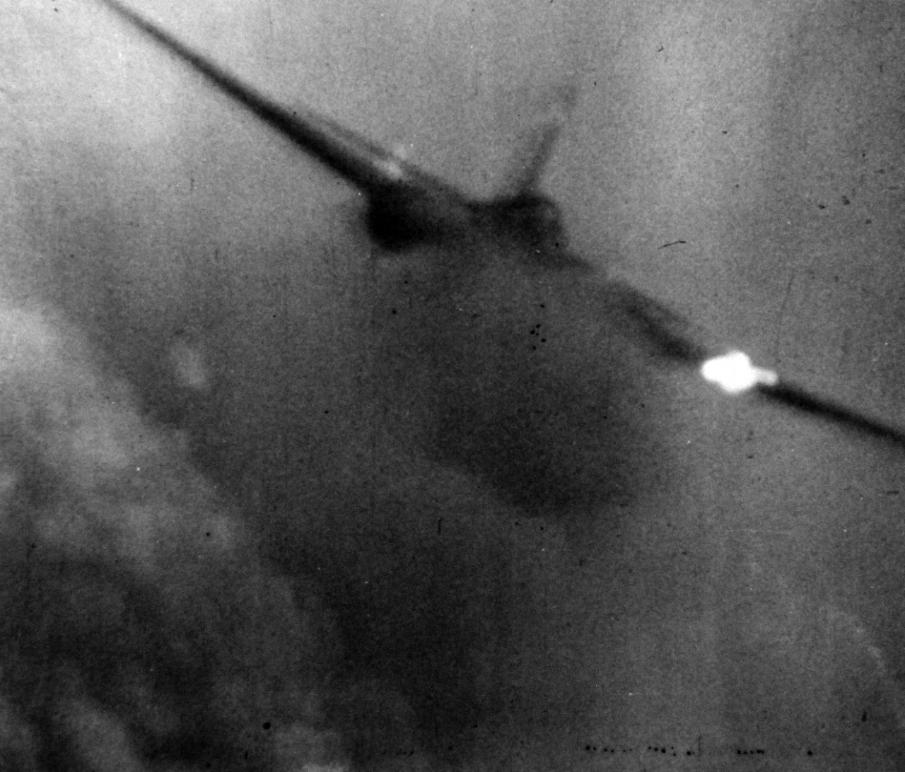 80-G-49708:   Japanese Kamikaze Attack, June 1945. Flames stream out from a Japanese Kamikaze as it is hit by anti-aircraft fire in its futile attempt to crash against the carrier.  Released June 28, 1945.   Official U.S. Navy photograph, now in the collections of the National Archives.  
