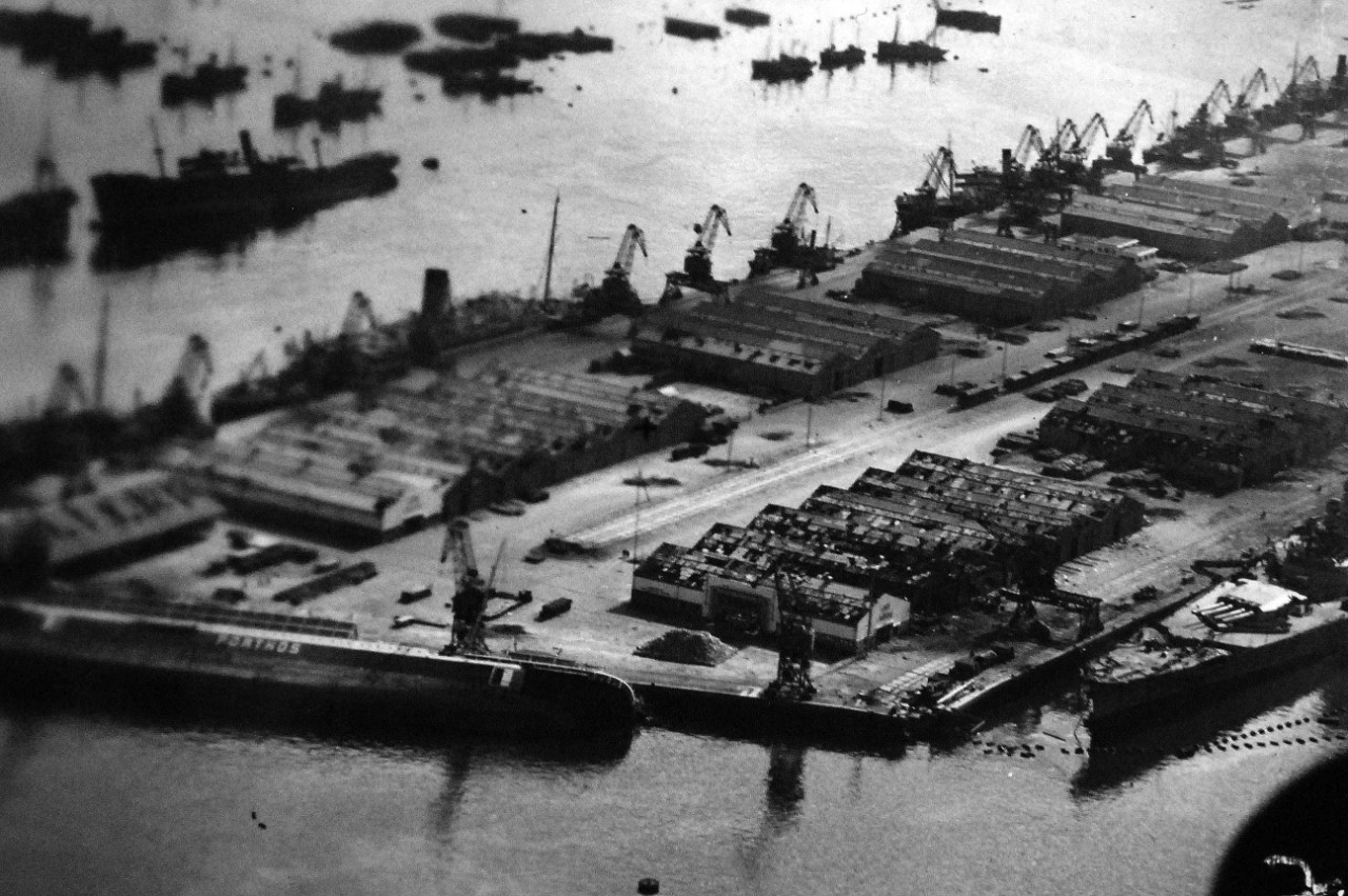 <p>80-G-37187: Naval Battle of Casablanca, November 8-16, 1942. Merchant ship SS Porthos on her side at Casablanca. She was damaged by shelling from USS Massachusetts. Aerial photograph taken by aircraft from USS Ranger (CV 4), 11 November 1942.&nbsp;</p>
