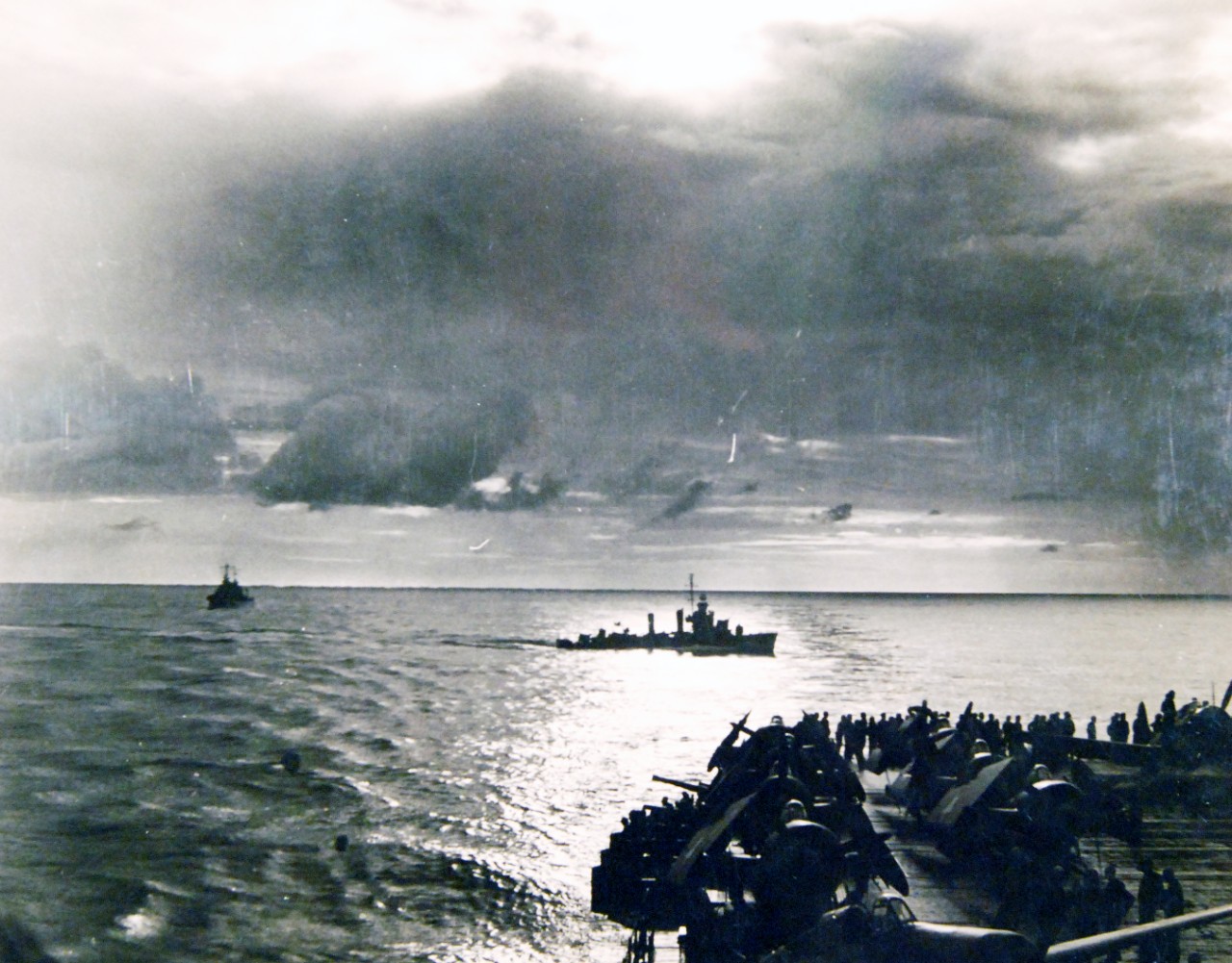 <p>80-G-30232: Operation Torch, November 1942. U.S. destroyer cuts through the wake of a U.S. aircraft carrier on patrol, first day of fighting off North Africa, November 8.&nbsp;</p>
